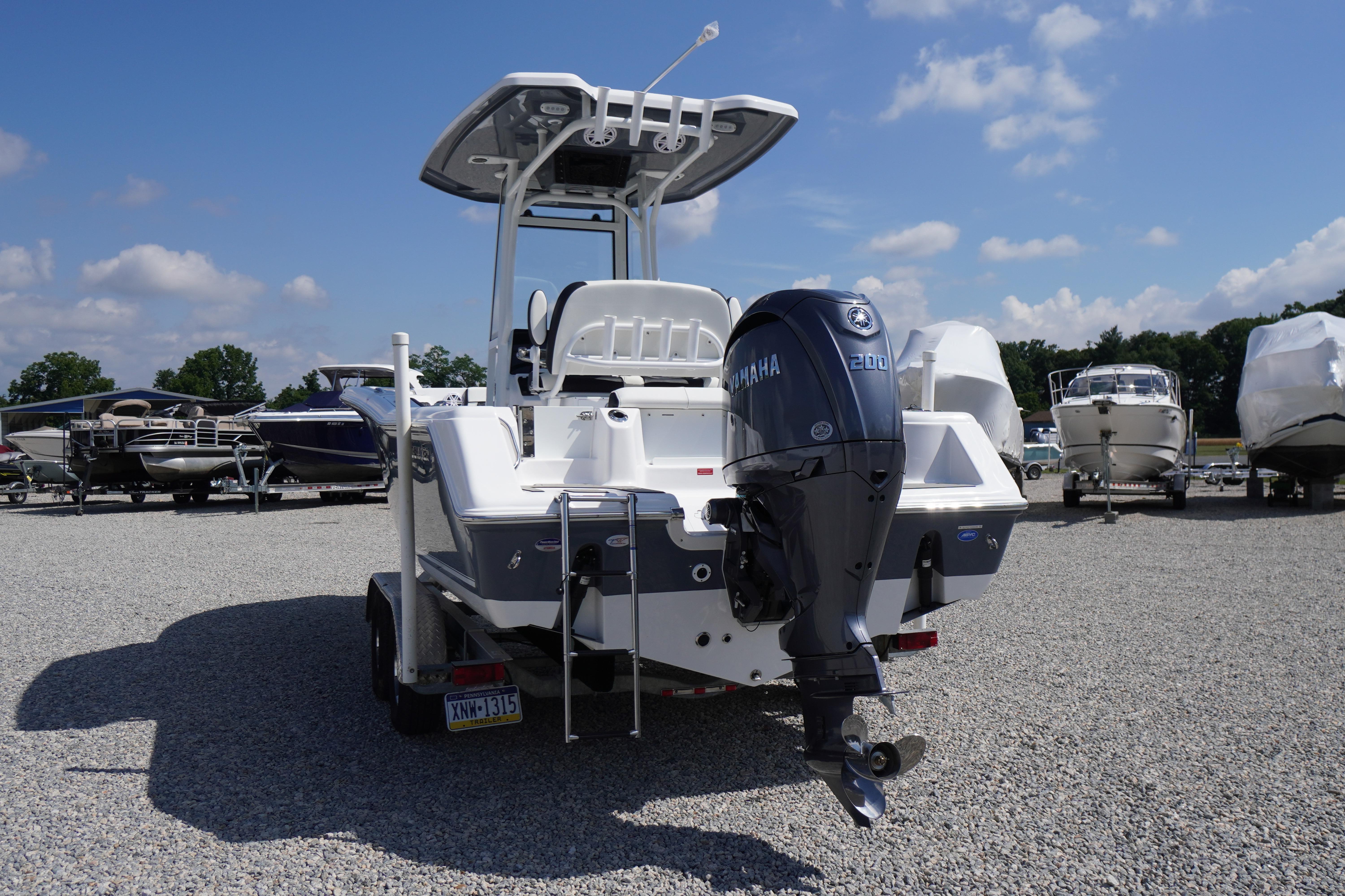 2026 Tidewater 220 CC Adventure boat with Yamaha engine, parked on gravel lot under blue sky.