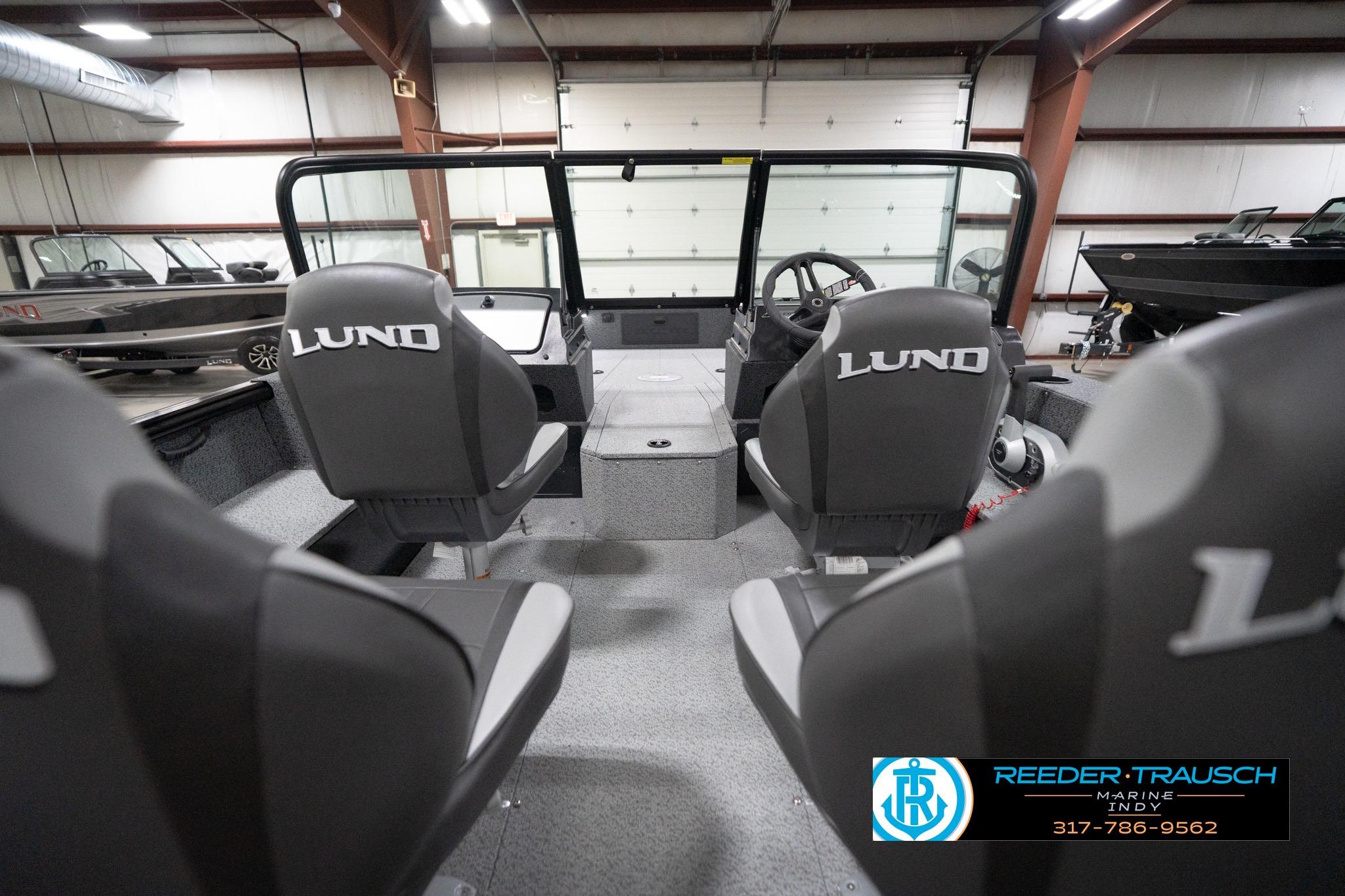 2026 Lund 1800 Explorer Sport boat interior with branded seats in a showroom.