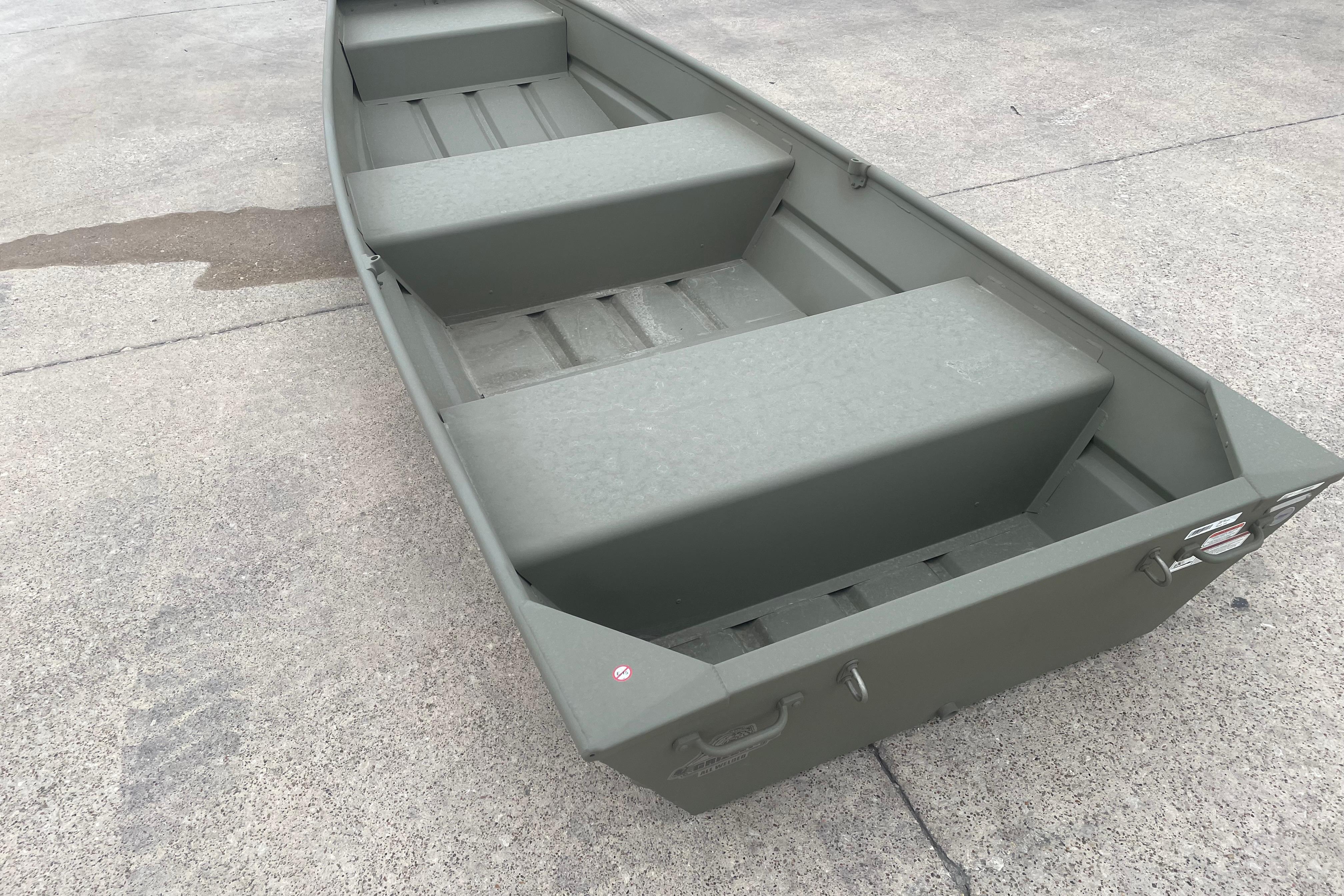 2026 Tracker Grizzly 12 Jon boat on concrete surface, showcasing interior seating and design.