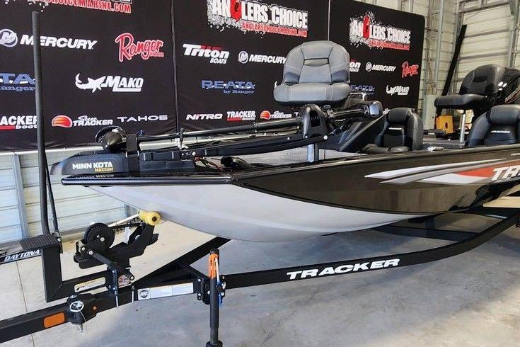 2026 Tracker Pro Team 175 boat on trailer in showroom setting.