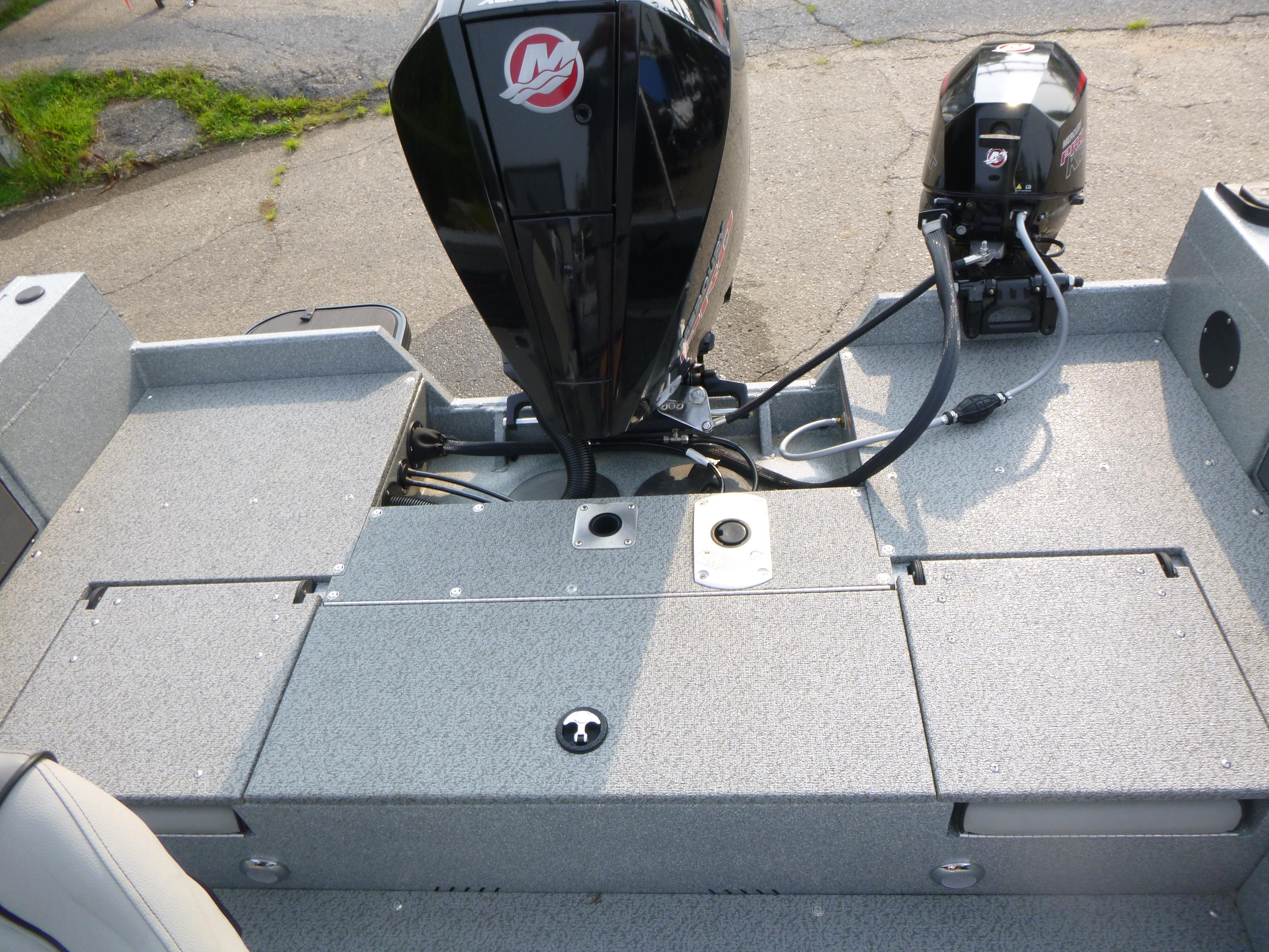 2025 KingFisher 2125 Arrow Sport boat with dual outboard motors on a textured deck.