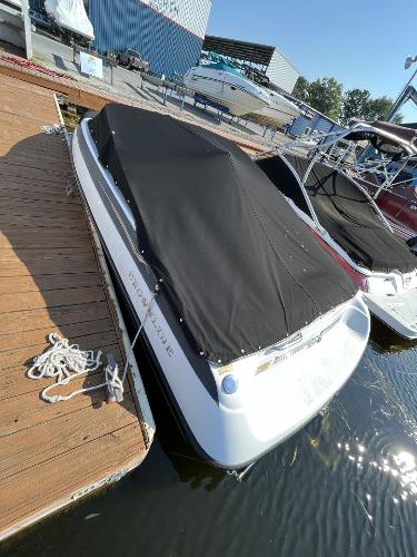 2005 Crownline 180 BR boat docked with black cover.