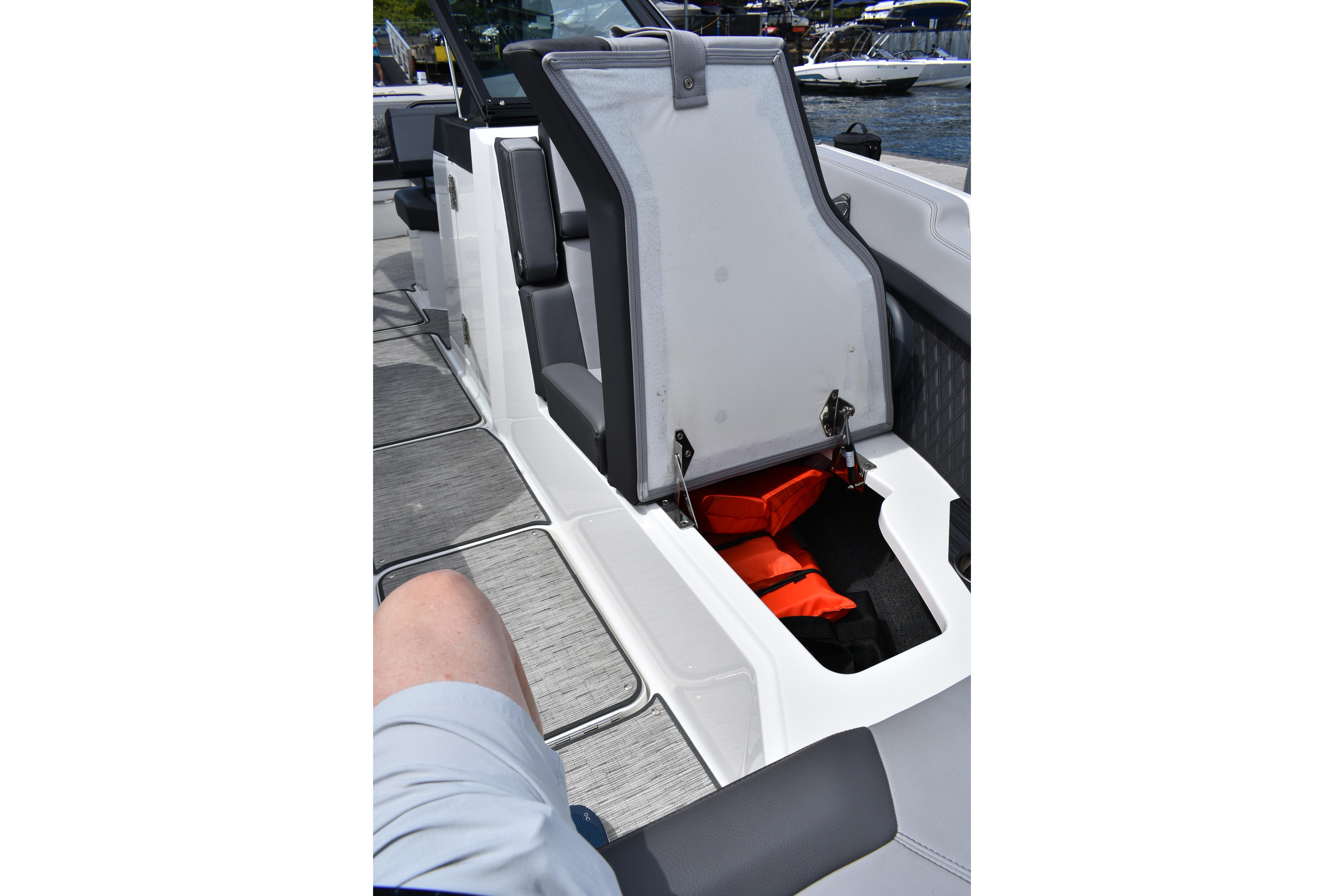 2023 Cobalt R8 boat interior with open storage compartment and life jackets.