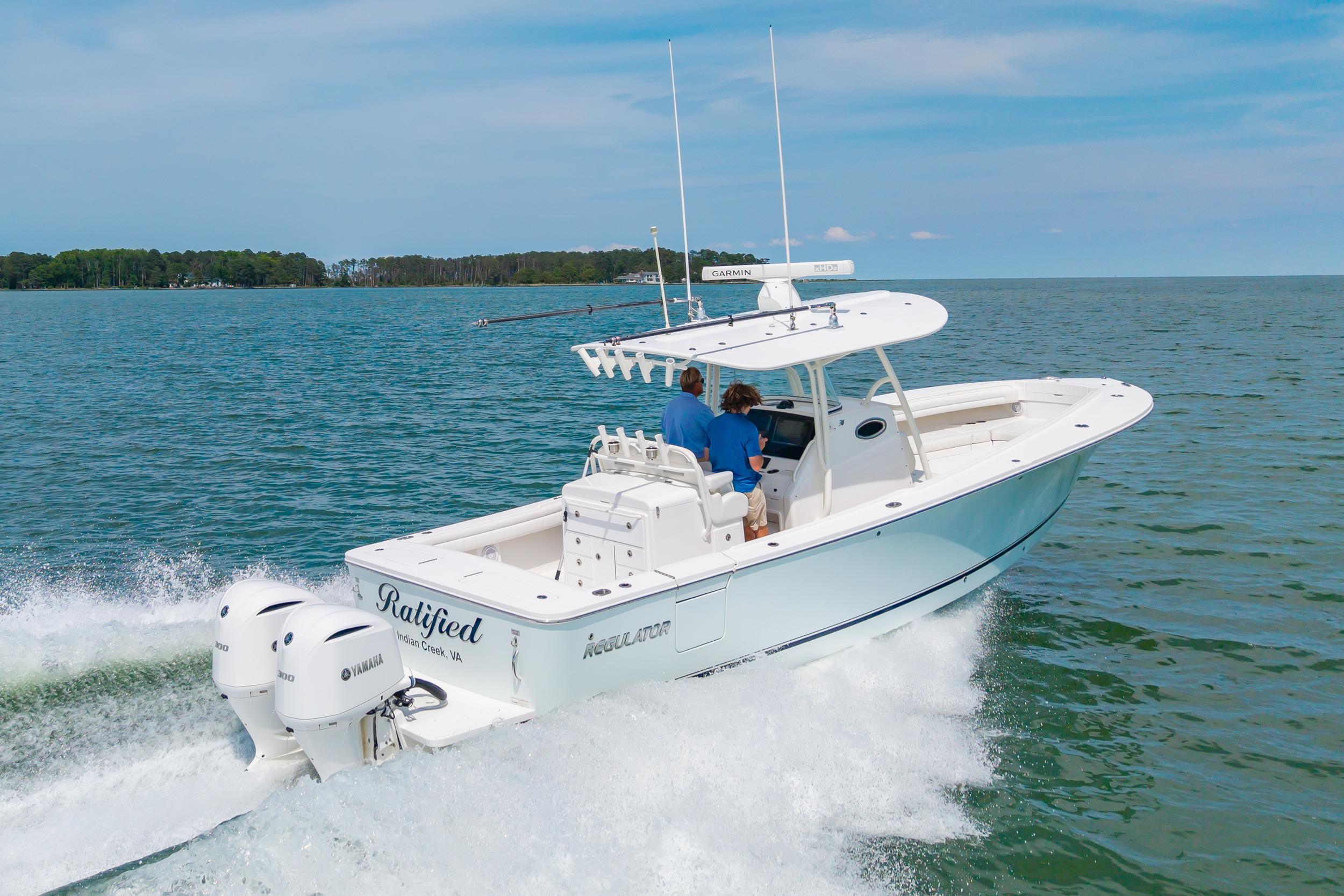 2019 Regulator 31 boat cruising on open water with twin Yamaha engines.