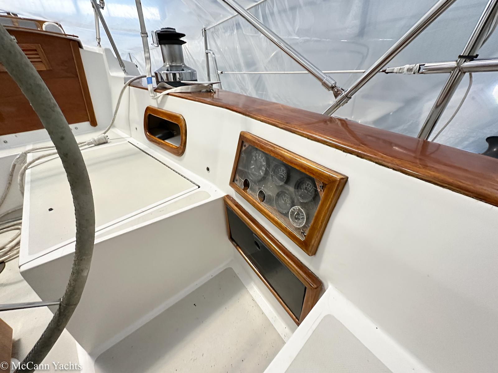 1988 Bristol 41.1 Aft Cockpit yacht interior with wooden trim and control panel.