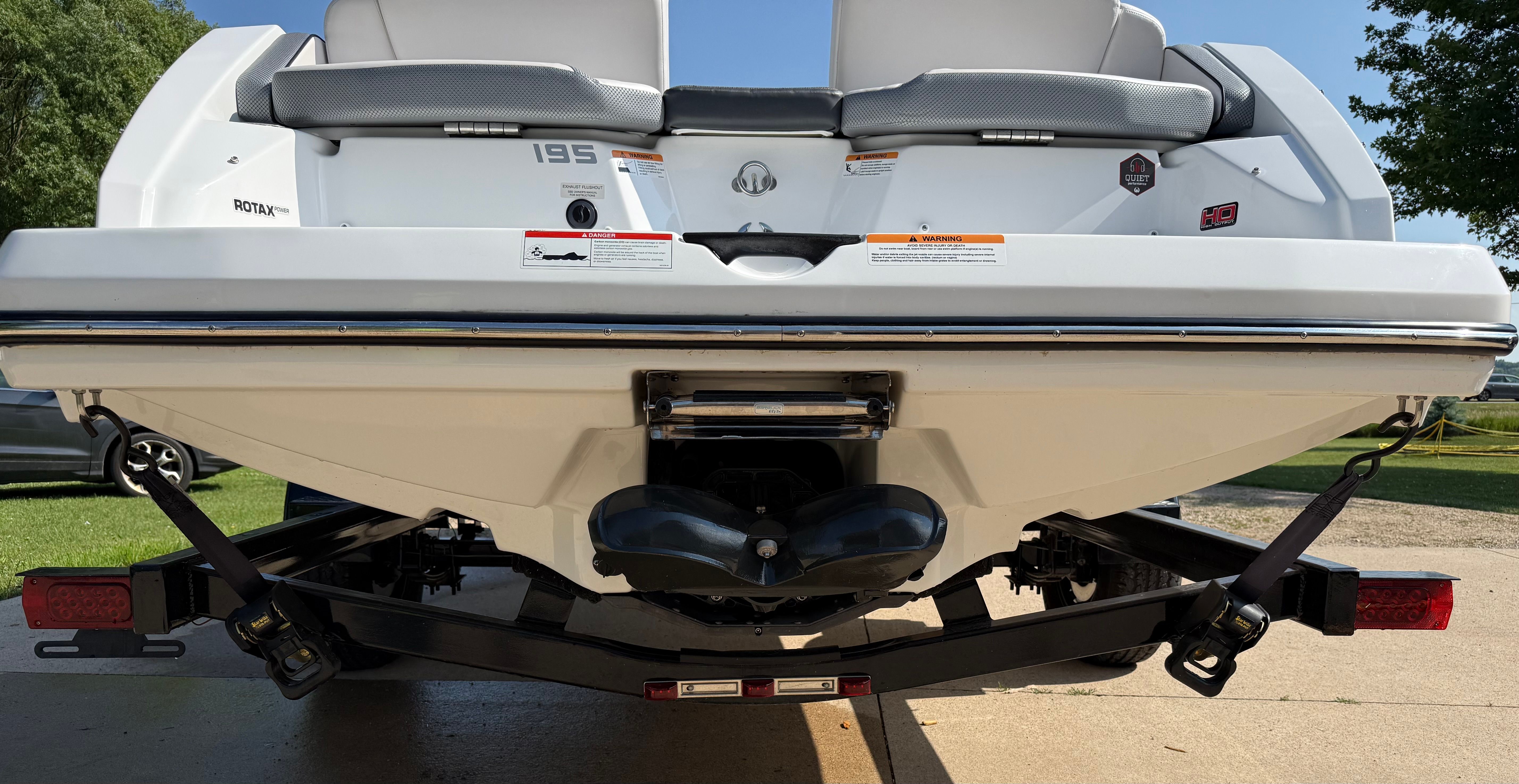 The image shows the rear of a 2023 Scarab 195 ID boat on a trailer.
