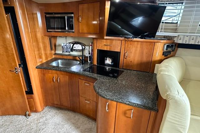 2004 Carver 360 Mariner interior with kitchenette, microwave, sink, and TV.