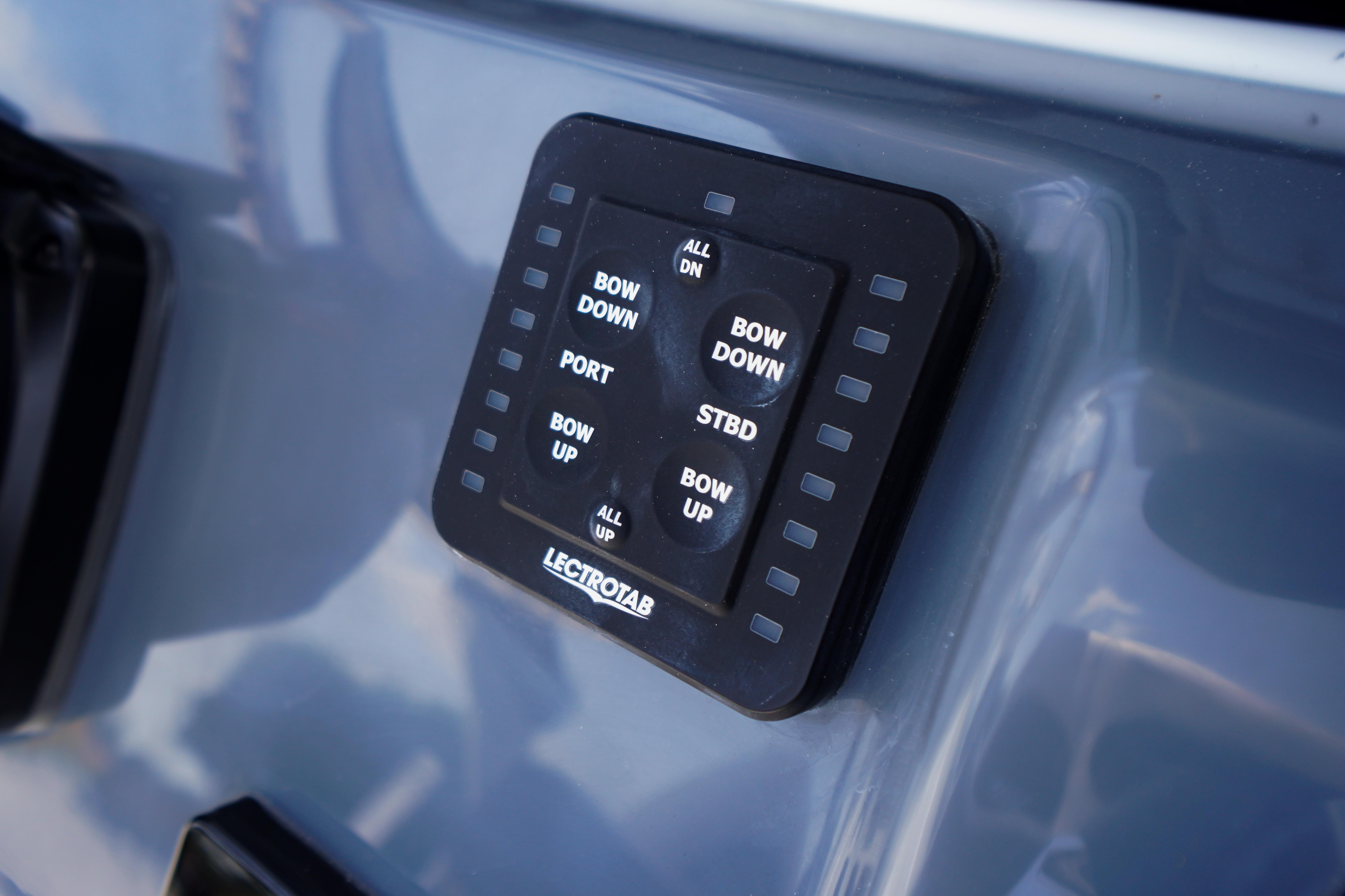 Control panel on 2027 Tidewater 220 CC Adventure boat, featuring Lectrotab trim tab buttons.