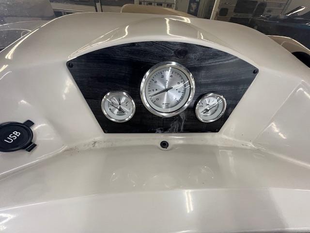 Dashboard of 2017 Harris Cruiser 200 boat with gauges and USB port.