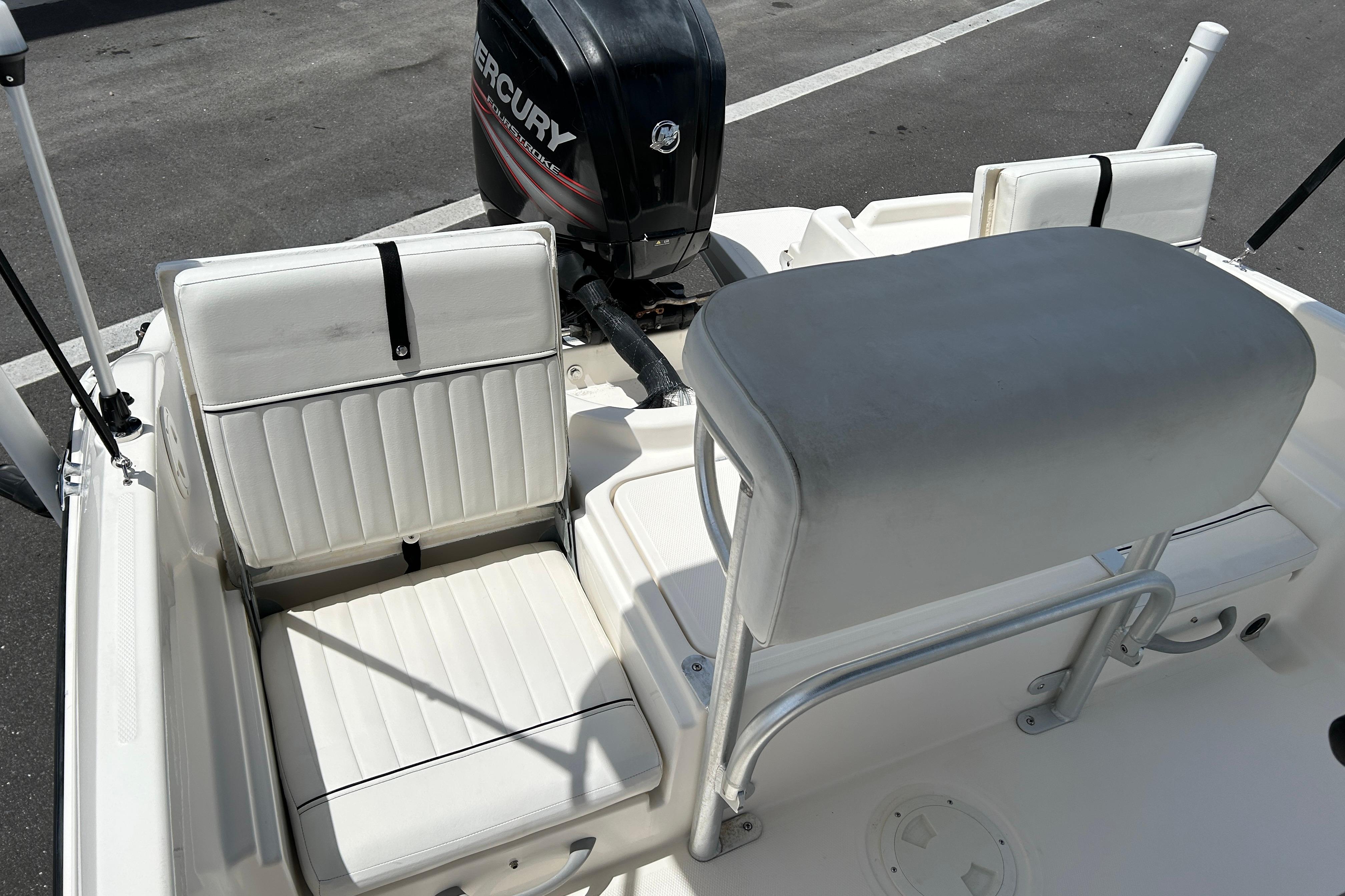 2018 Bayliner Element F16 boat interior with white seating and Mercury outboard motor.