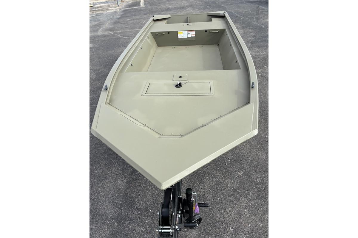 2026 Tracker Grizzly 1648 Utility boat on pavement, showcasing spacious interior design.