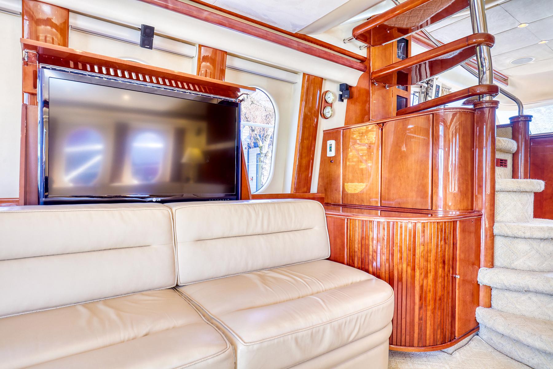 Luxurious interior of 2001 Viking Sport Cruisers Motoryacht with leather sofa and TV.