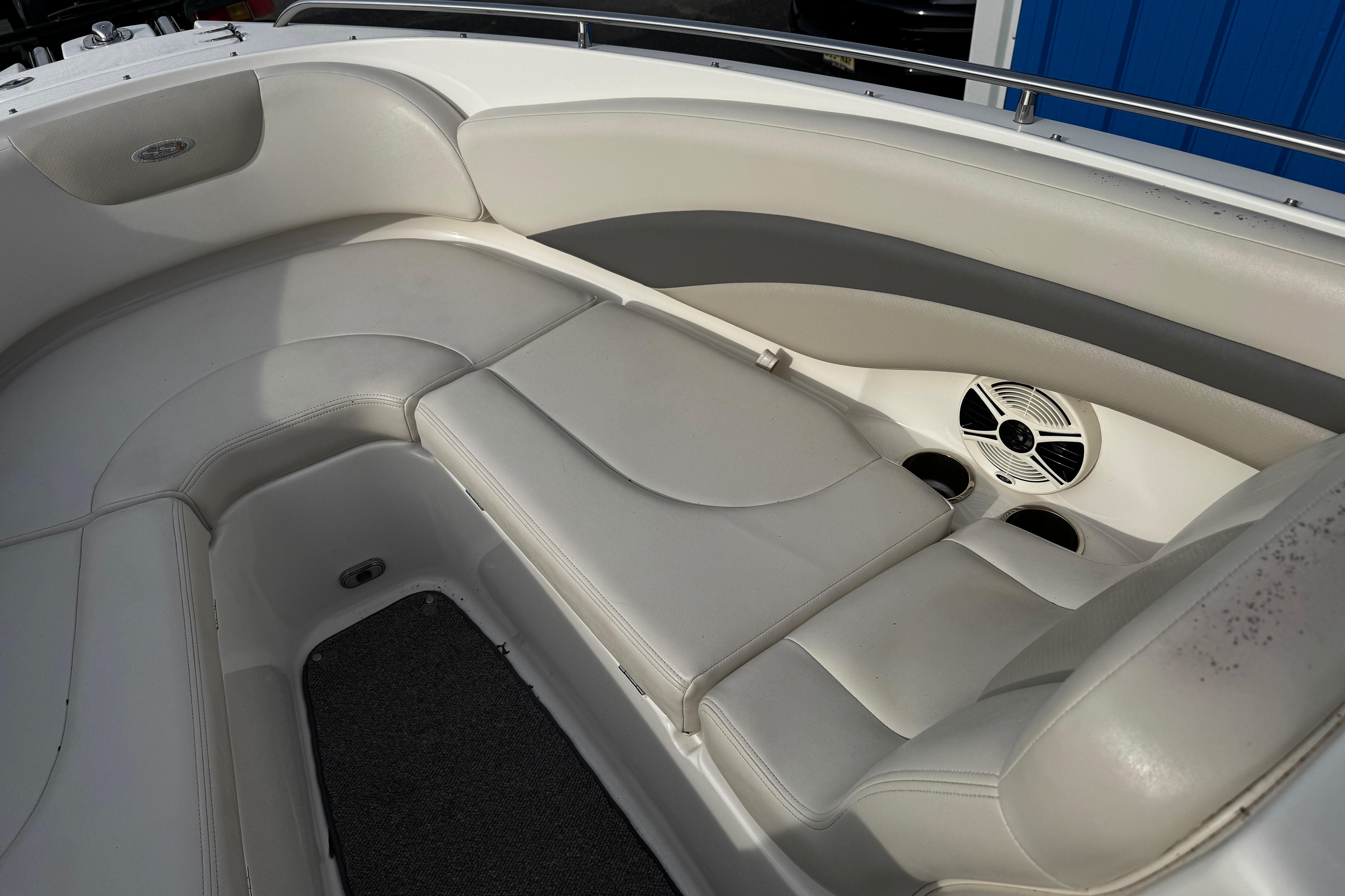 2008 Chaparral 256 SSi boat interior with white leather seating and speaker system.