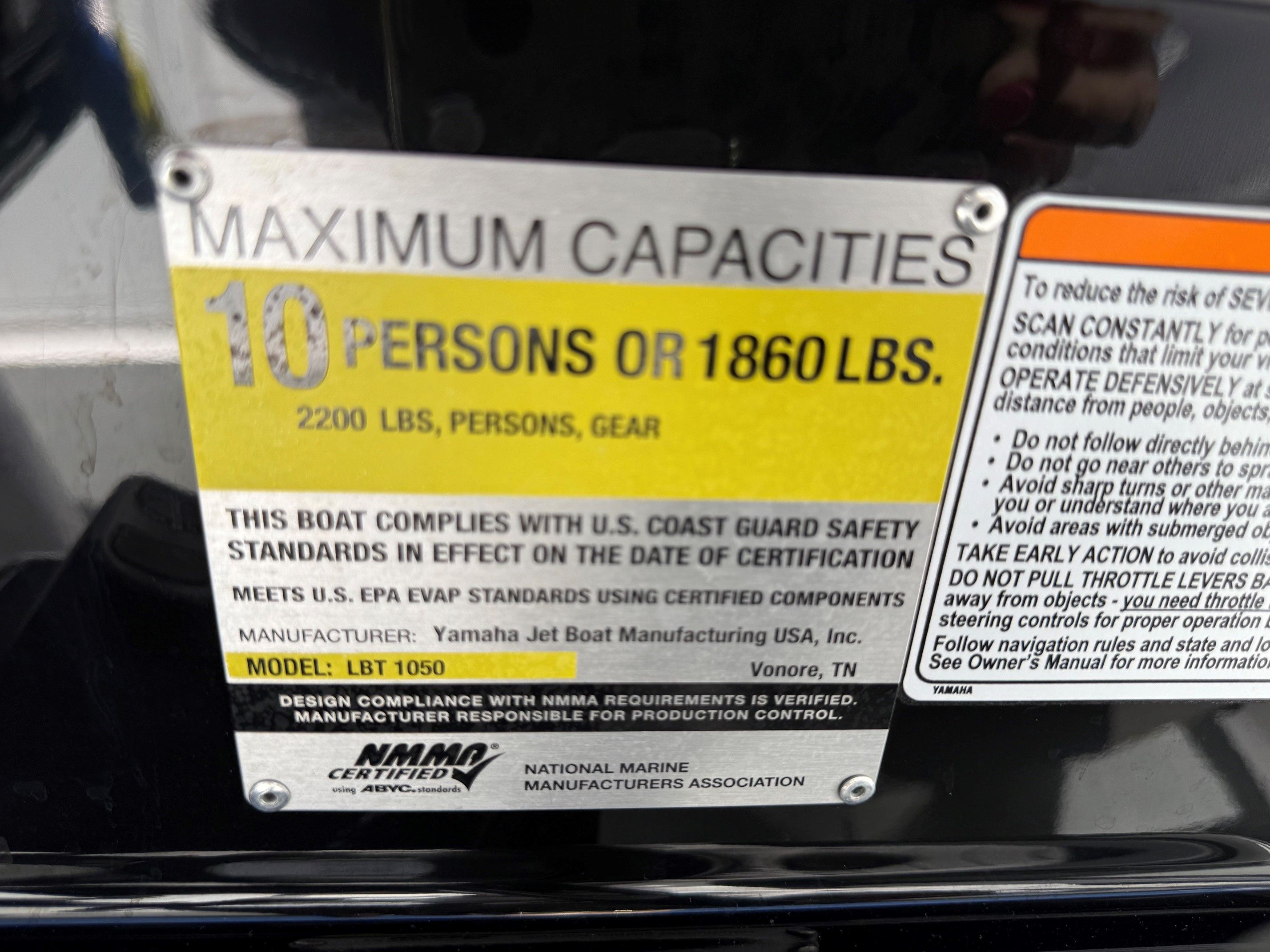 A label on a Yamaha boat shows maximum capacities and safety information.