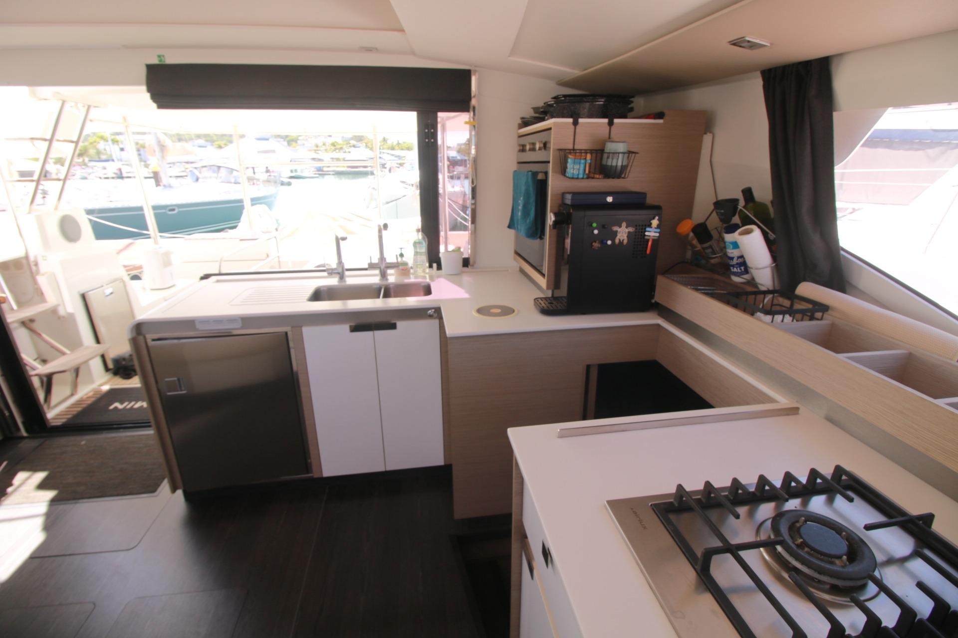Modern kitchen interior of 2022 Fountaine Pajot Elba 45 Catamaran with sleek appliances.