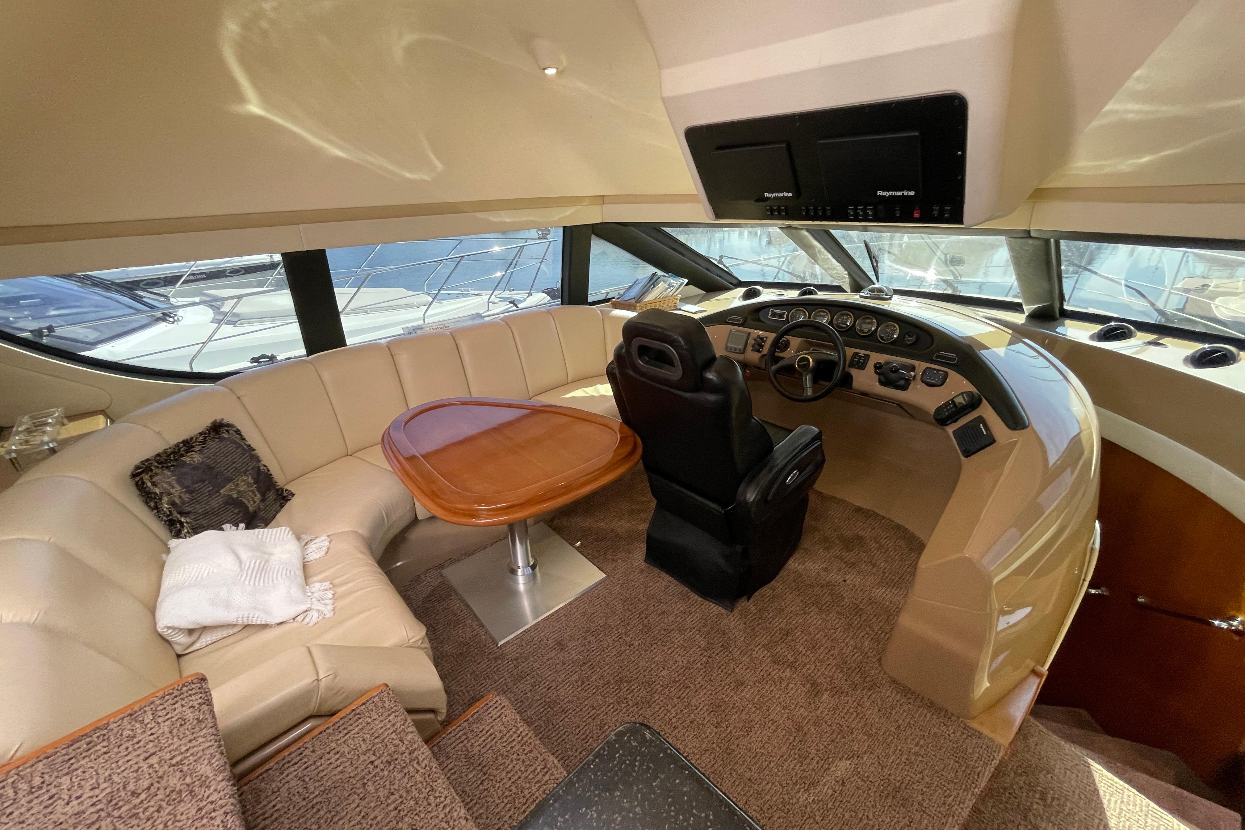 Luxurious interior of 2002 Carver 570 Voyager Pilothouse with helm and seating area.