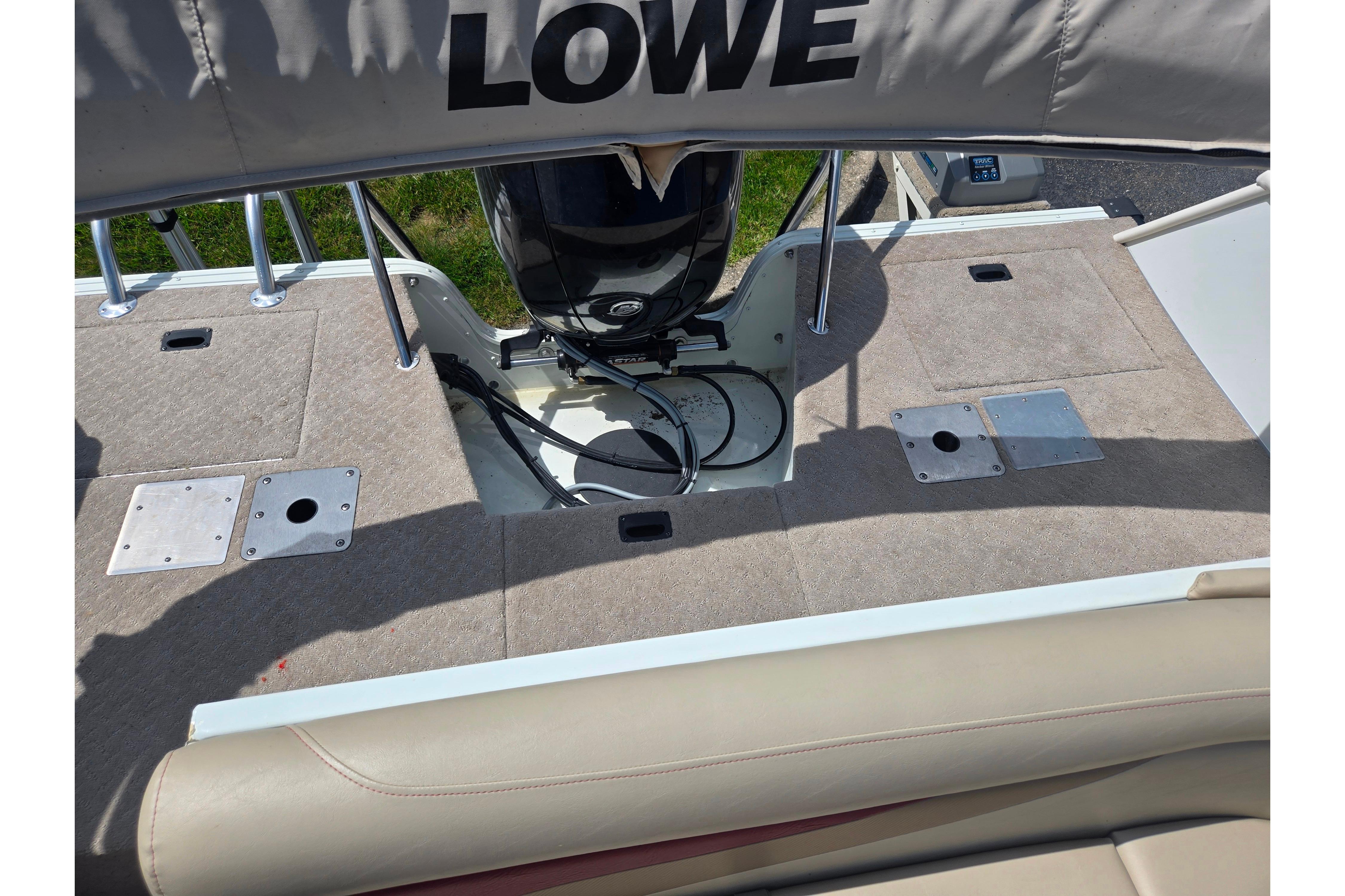 2015 Lowe Sport Deck 224 boat deck with motor and seating area.