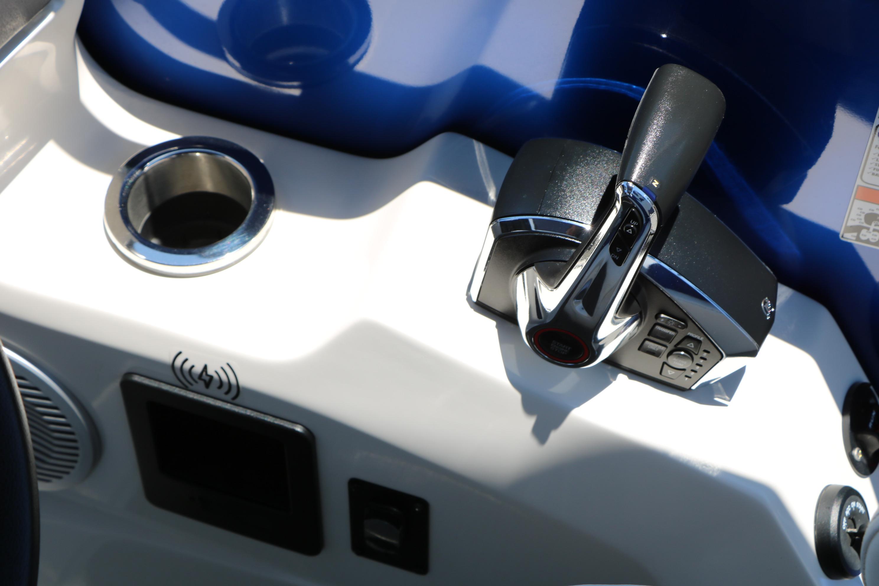 2024 Bennington 23 RX SWINGBACK boat control panel with throttle and cup holder.