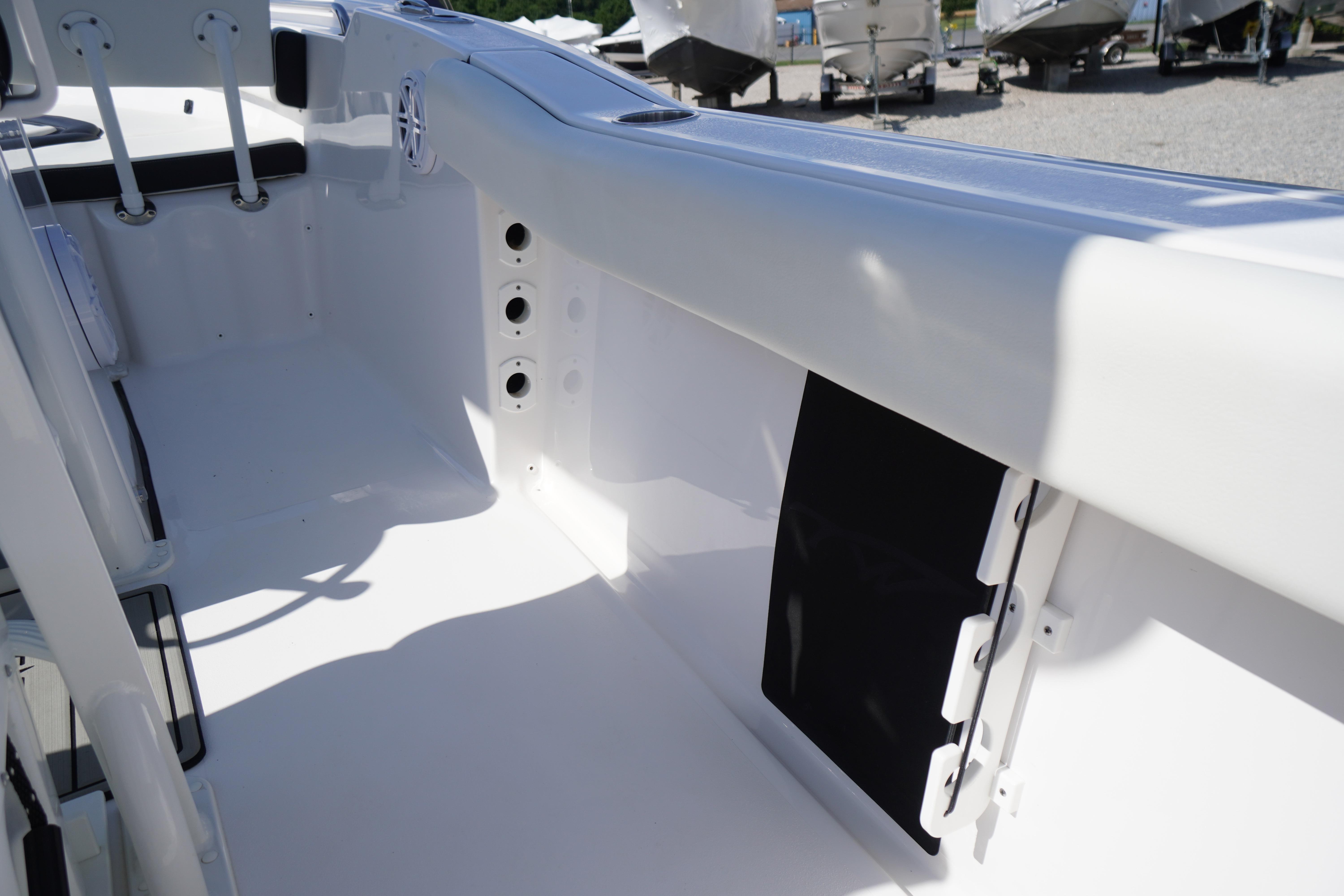2025 Tidewater 232 SS boat interior, showcasing sleek white design and seating area.