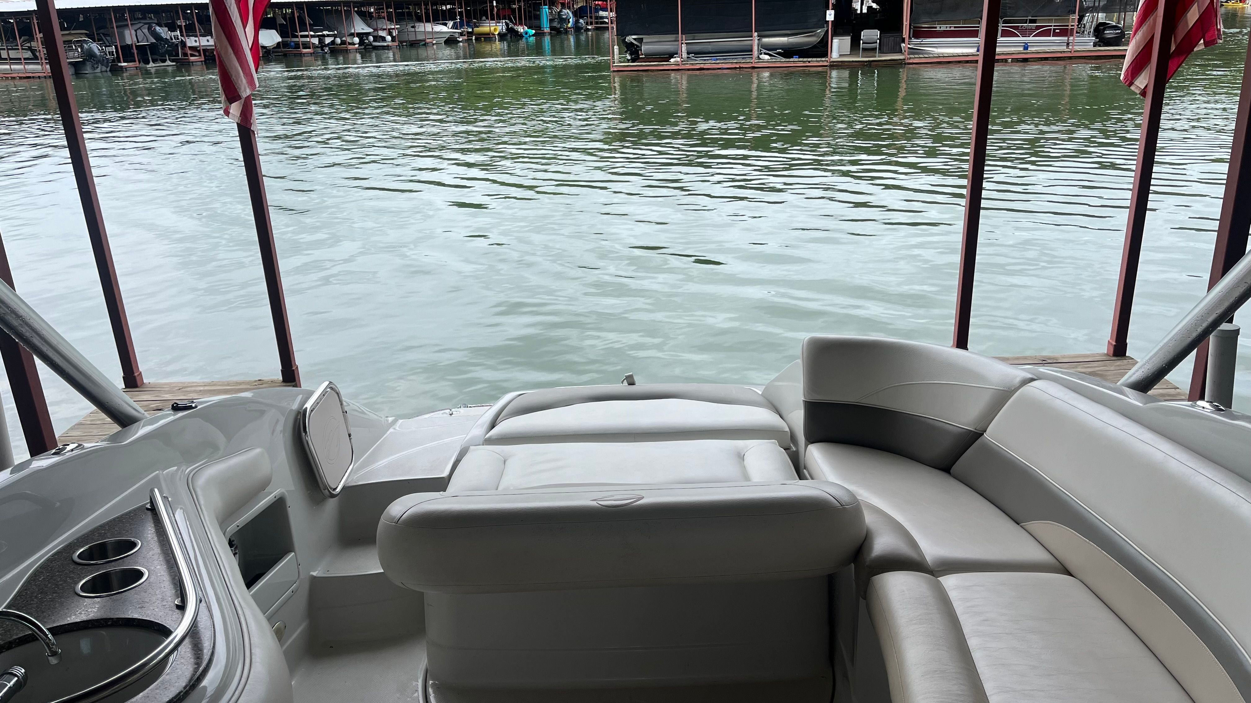 Interior view of a 2008 Crownline 252EX boat with gray seating and cup holders.