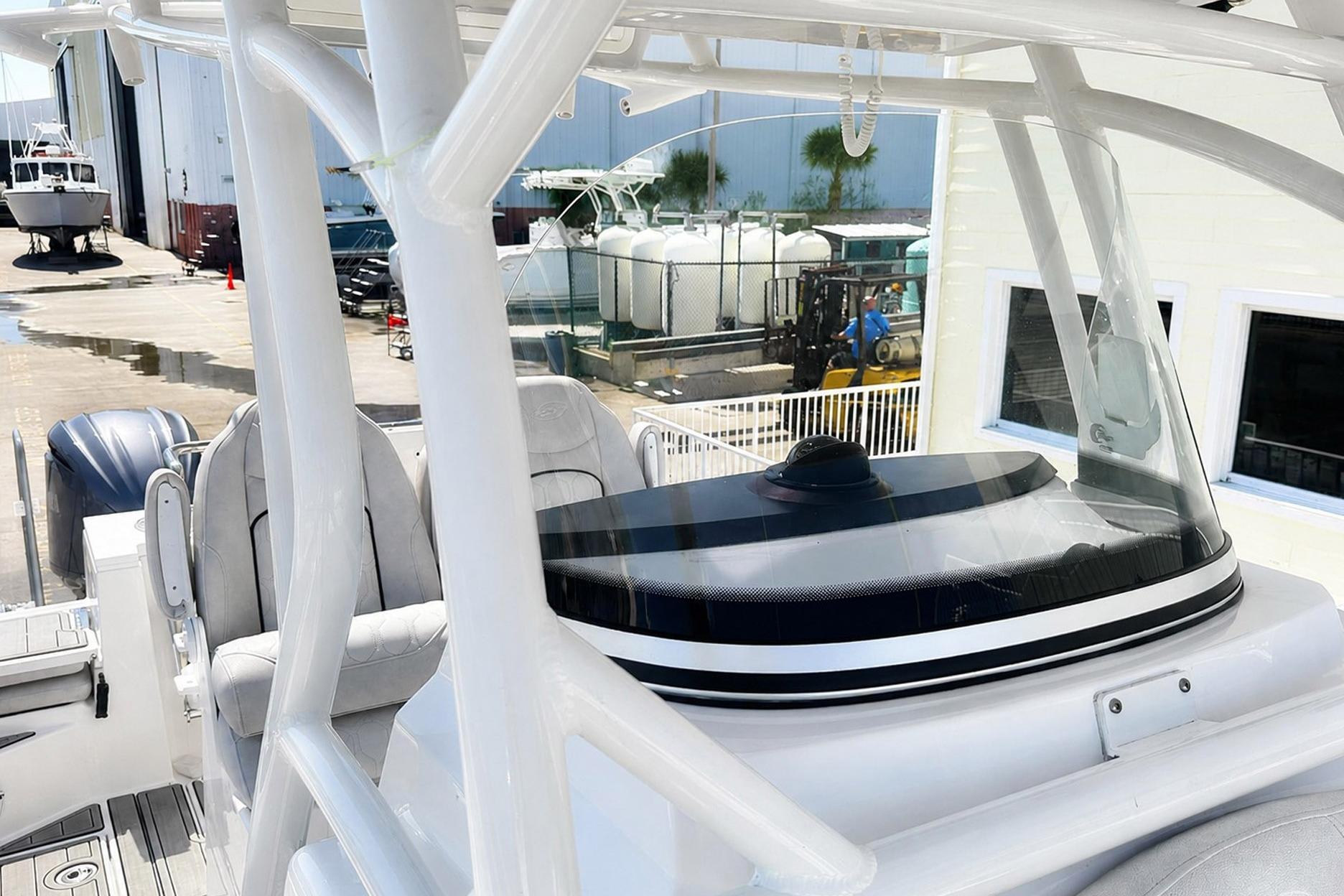 Sea Fox 228 Commander boat interior, showcasing helm and seating, docked at a marina.