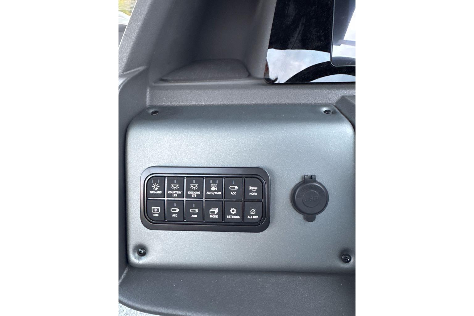 Control panel of 2026 Sun Tracker Fishin' Barge 22 DLX with various switches.