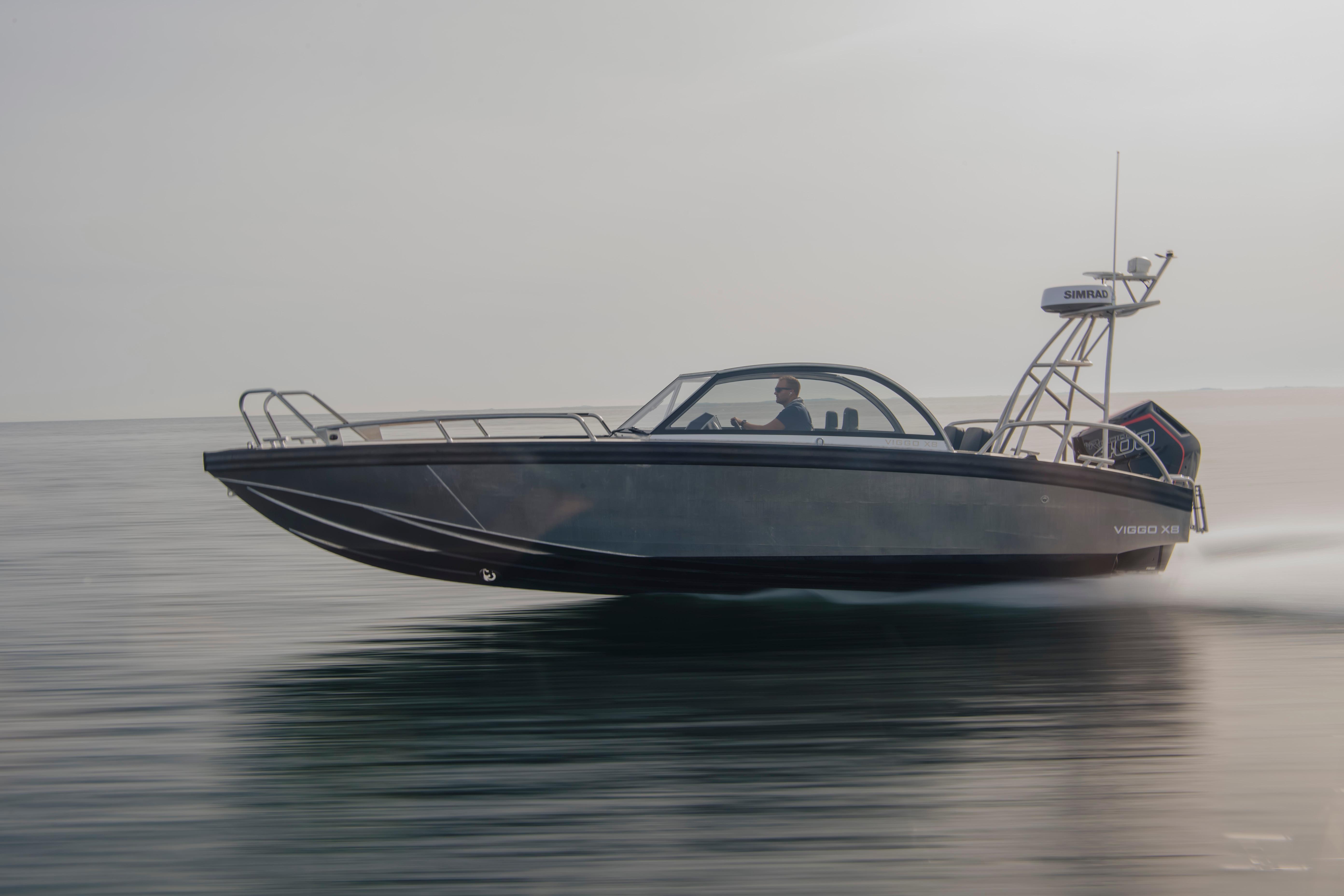 Sleek 2025 Viggo X8 speedboat cruising swiftly on calm waters.