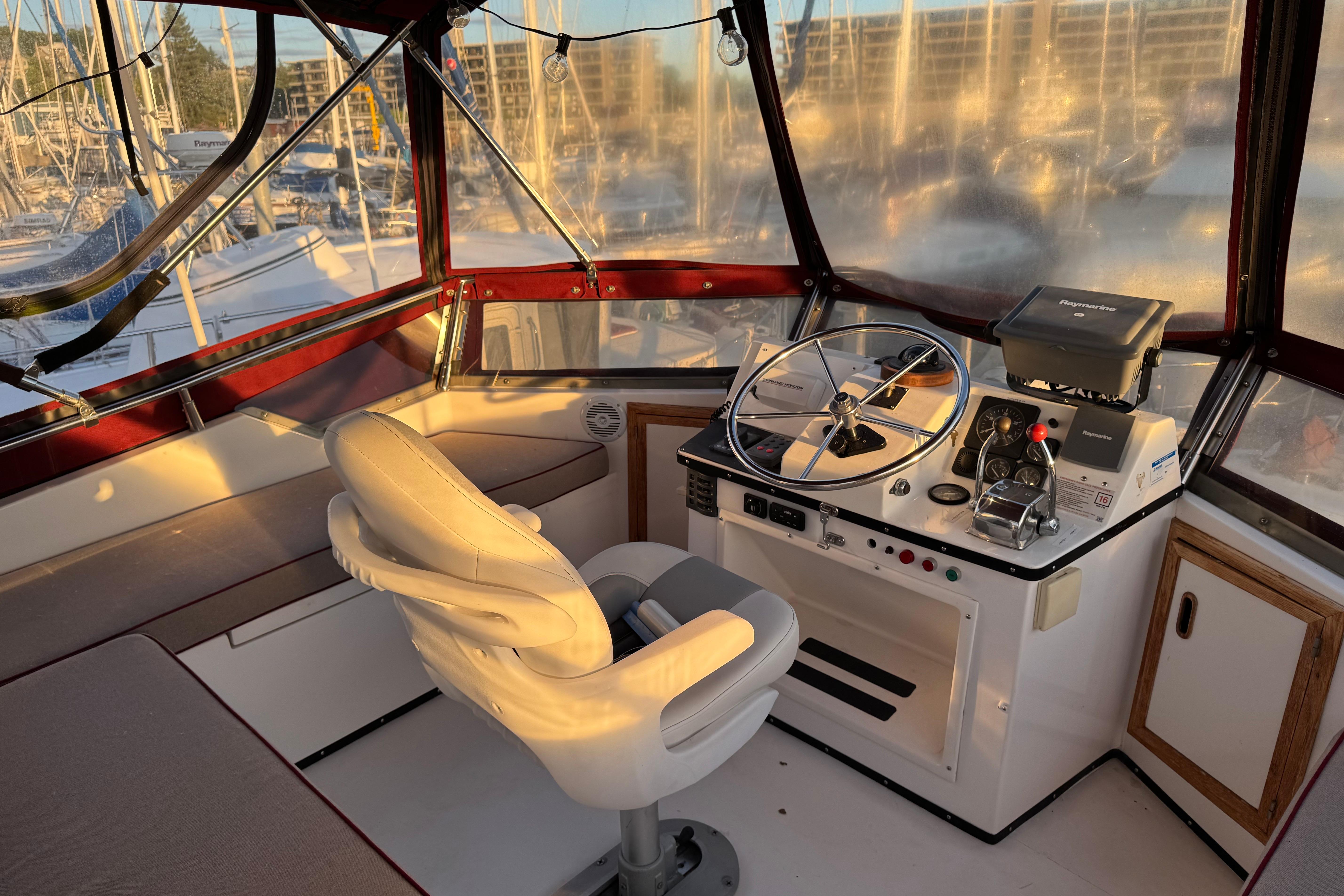 Cockpit of a 1987 President 37 yacht with steering wheel and navigation equipment.