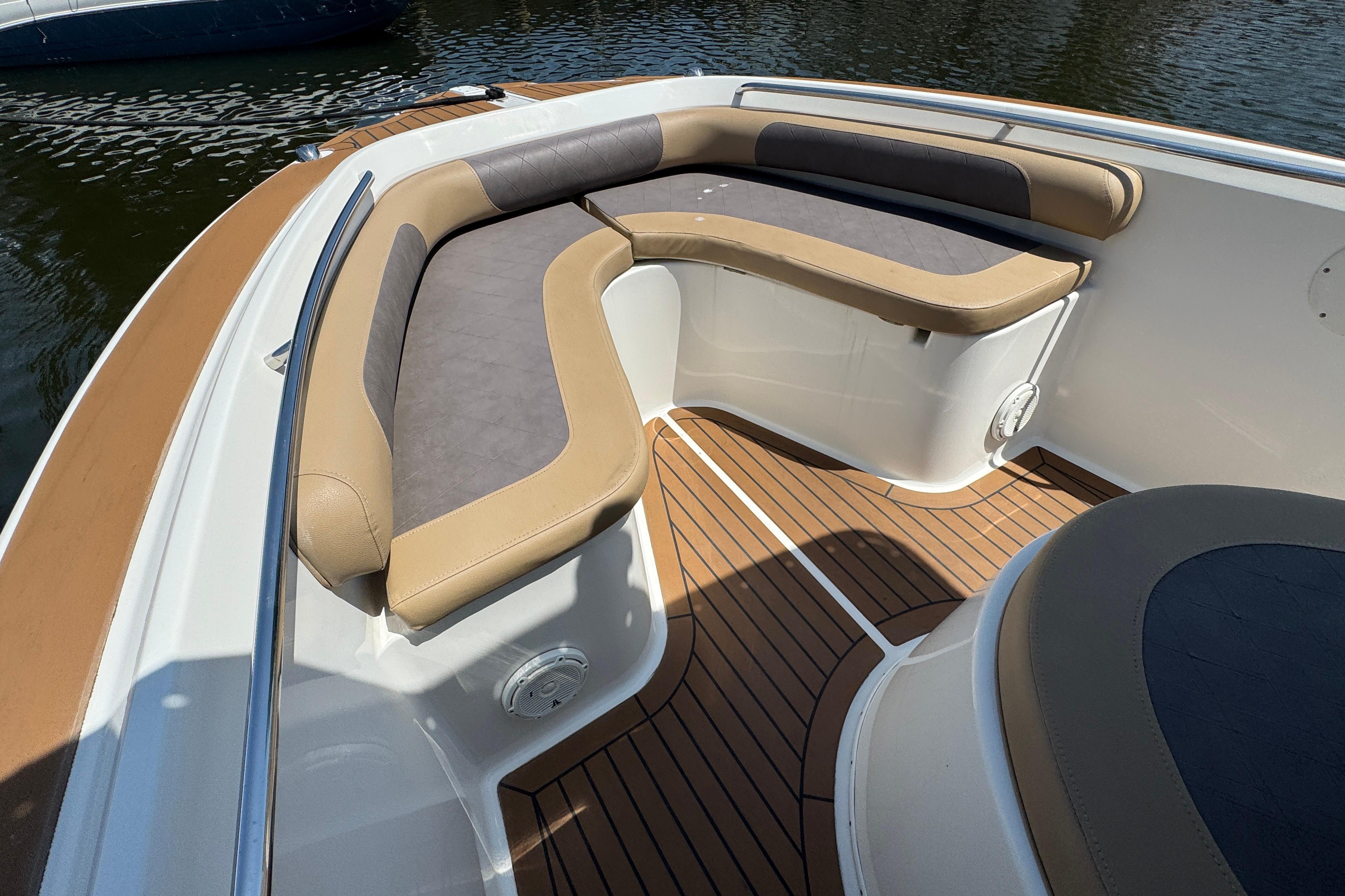 2014 Century 2301 Center Console boat with cushioned seating and wood-patterned flooring.