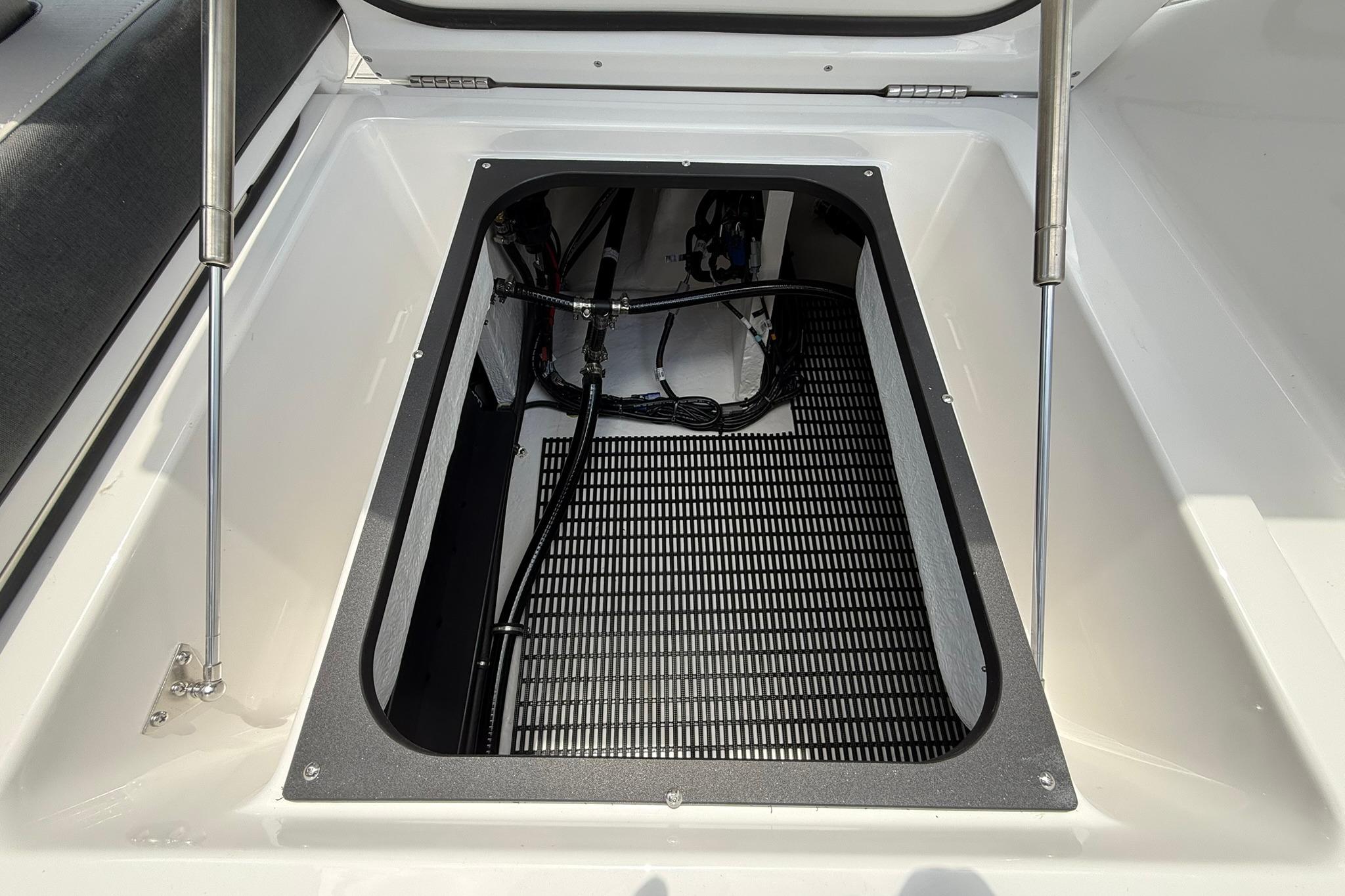 Storage compartment of 2027 Monterey Elite 30 OB boat, featuring hydraulic lift supports.