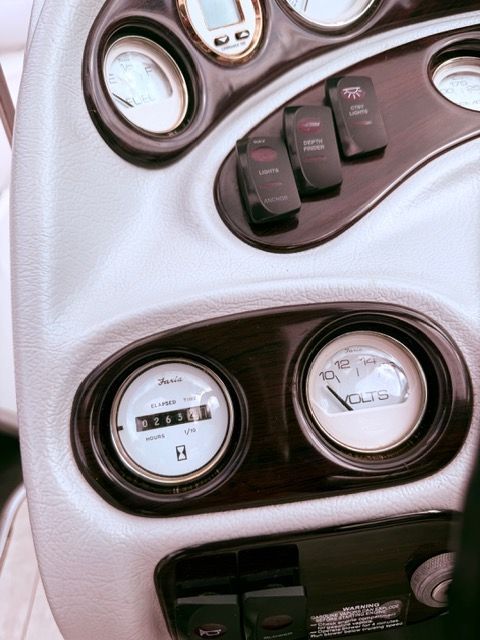Close-up of a 2001 Mariah Shabah boat dashboard with various gauges and switches.