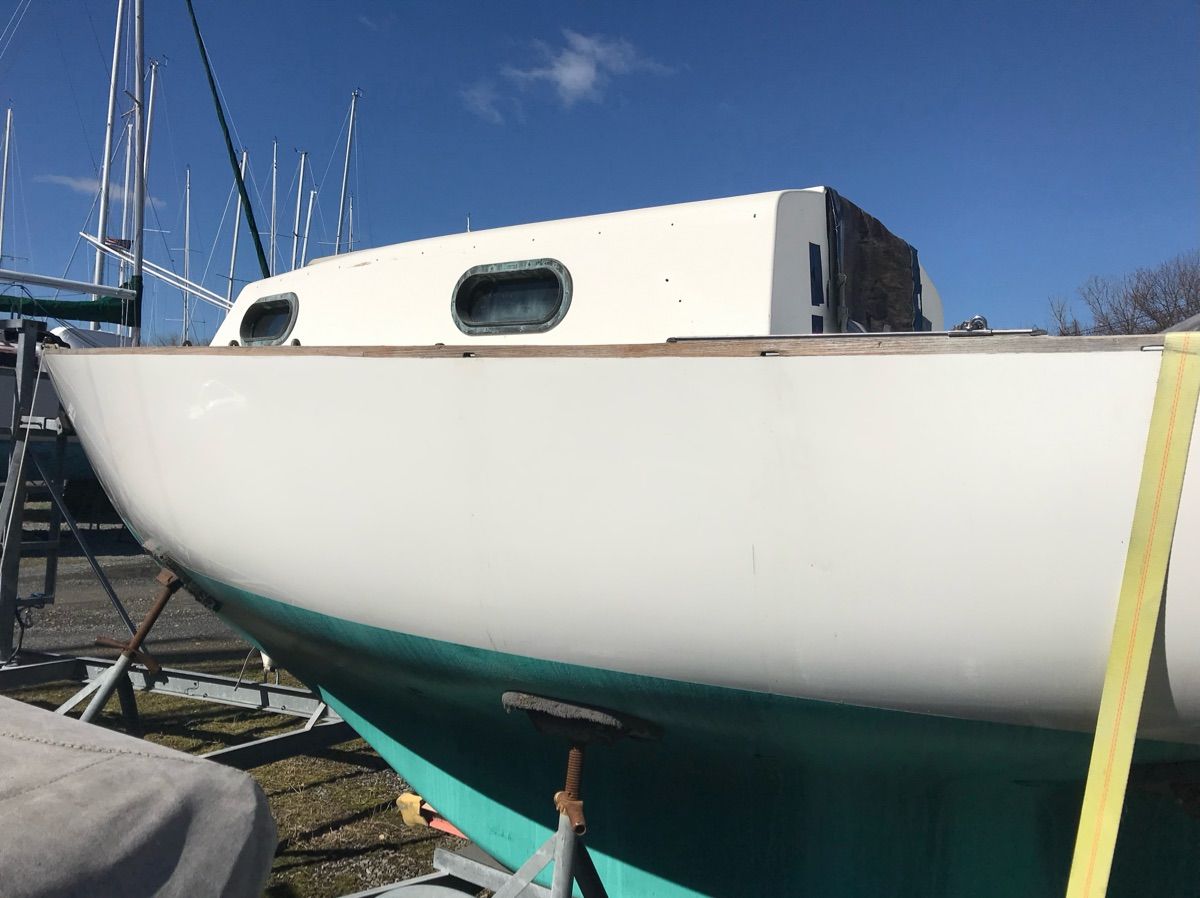 A 1981 Cape Dory 22-1 sailboat is on a stand on land.