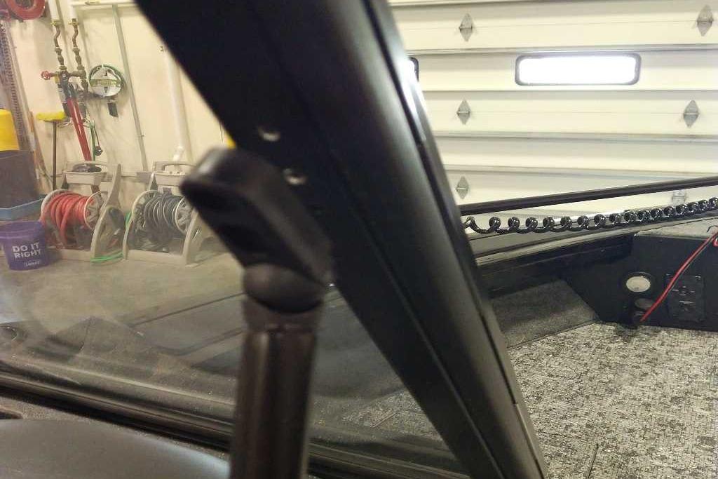 2026 Tracker Targa V-18 Combo interior, garage setting, visible equipment and coiled cable.