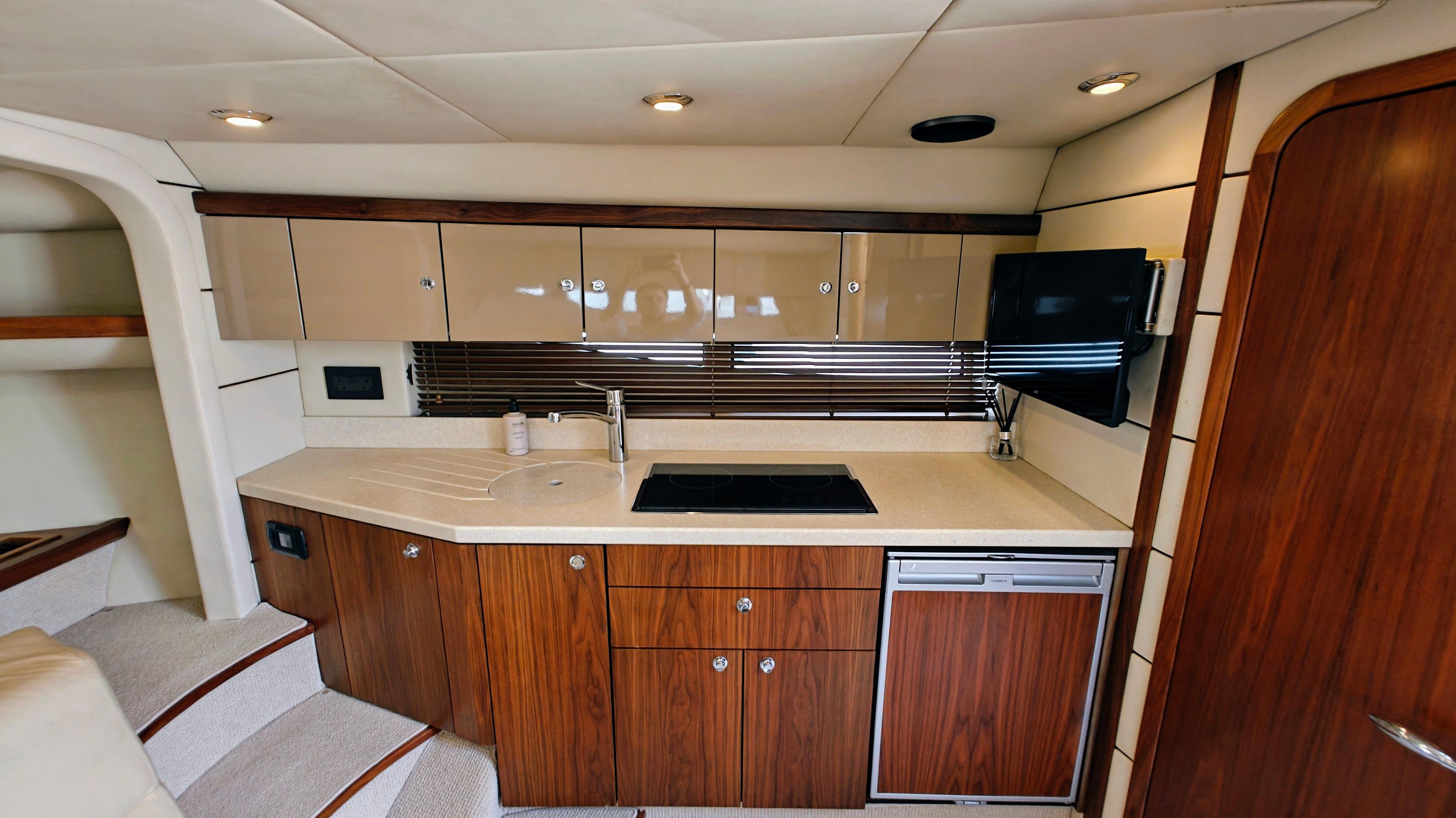 Luxurious interior of 2007 Sunseeker Superhawk 43 yacht with modern kitchen amenities.