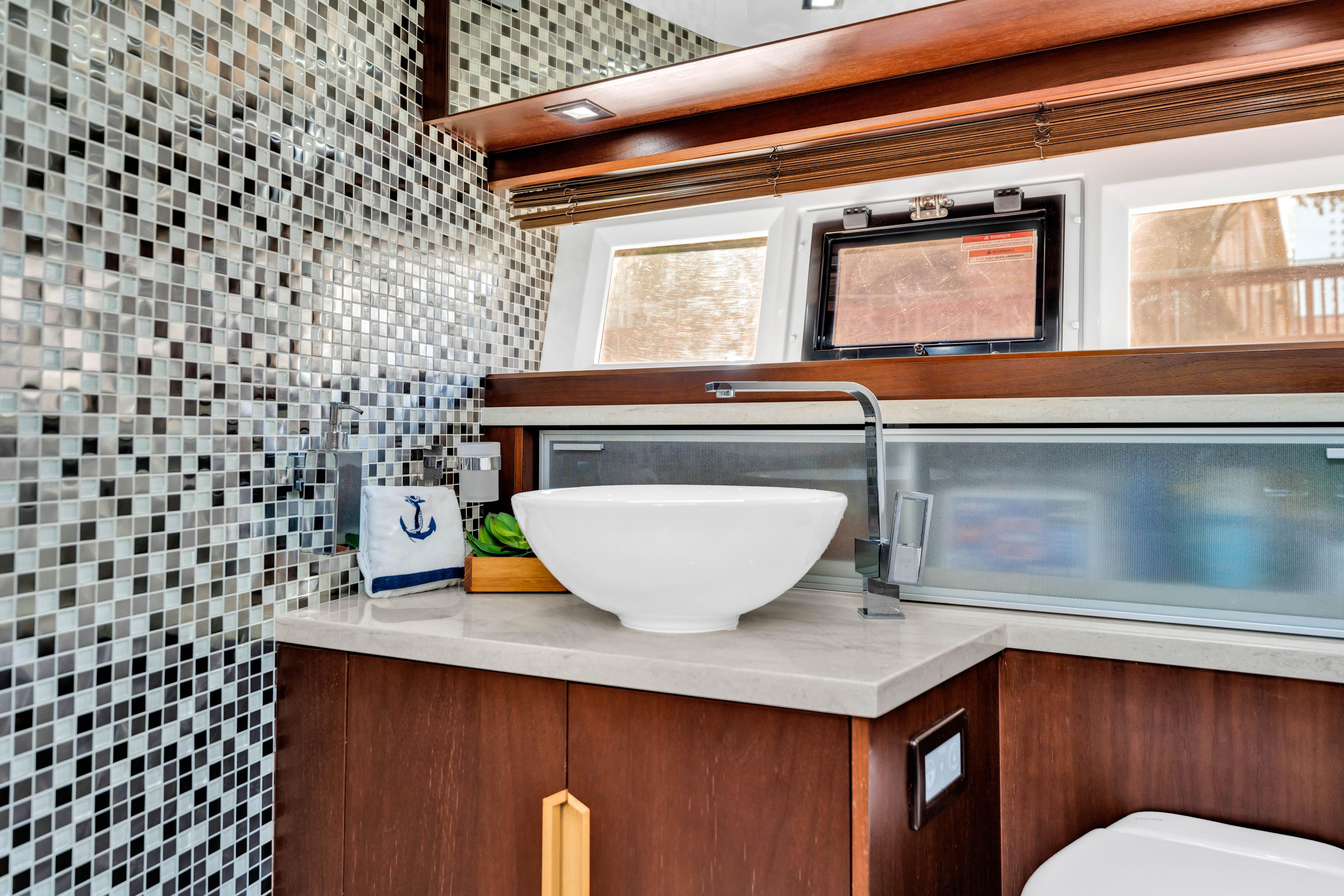 Luxurious bathroom in 2016 Galeon 430 HTC yacht with modern sink and mosaic tiles.