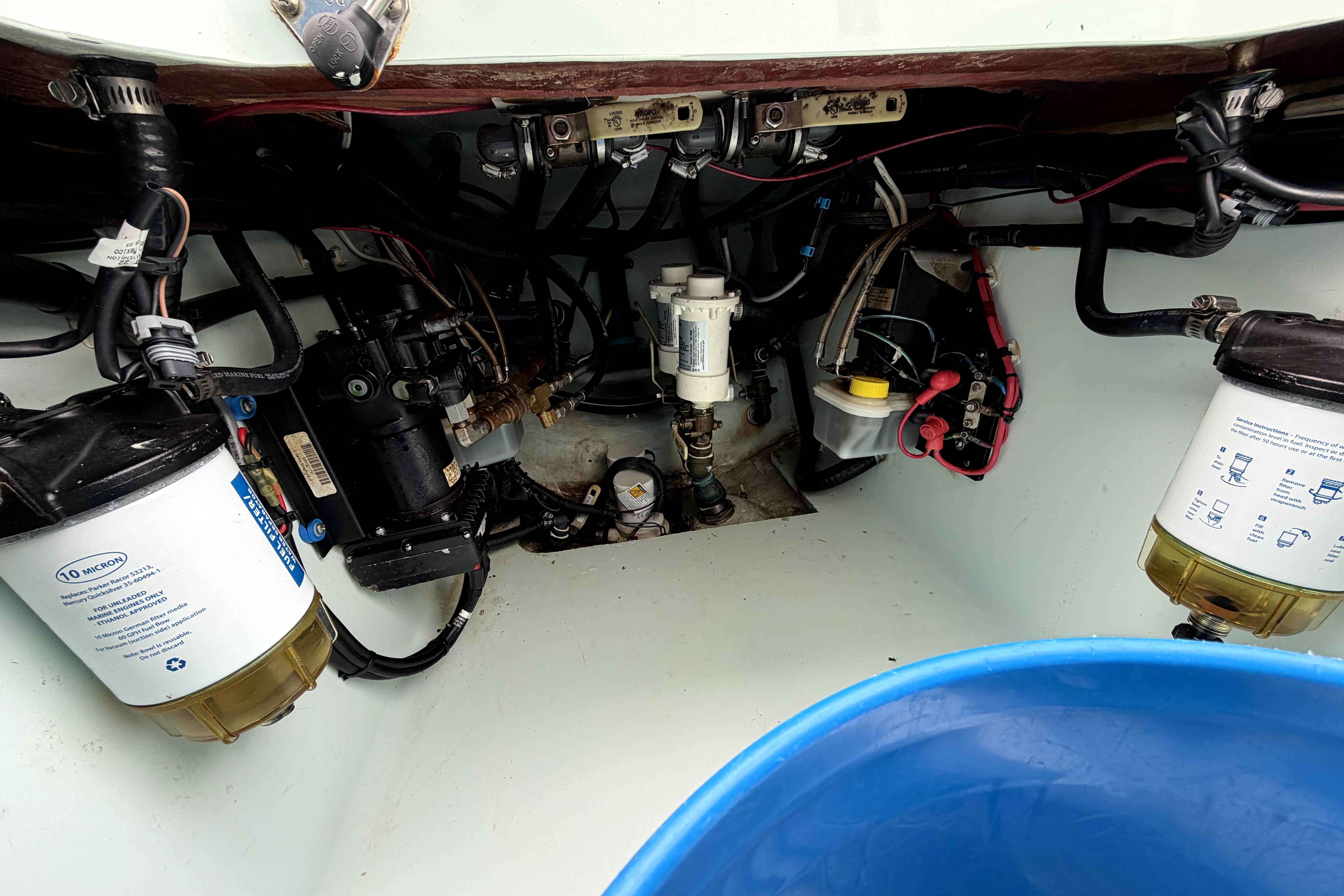 Engine compartment of a 2019 Contender 30 ST boat, showcasing fuel filters and wiring.