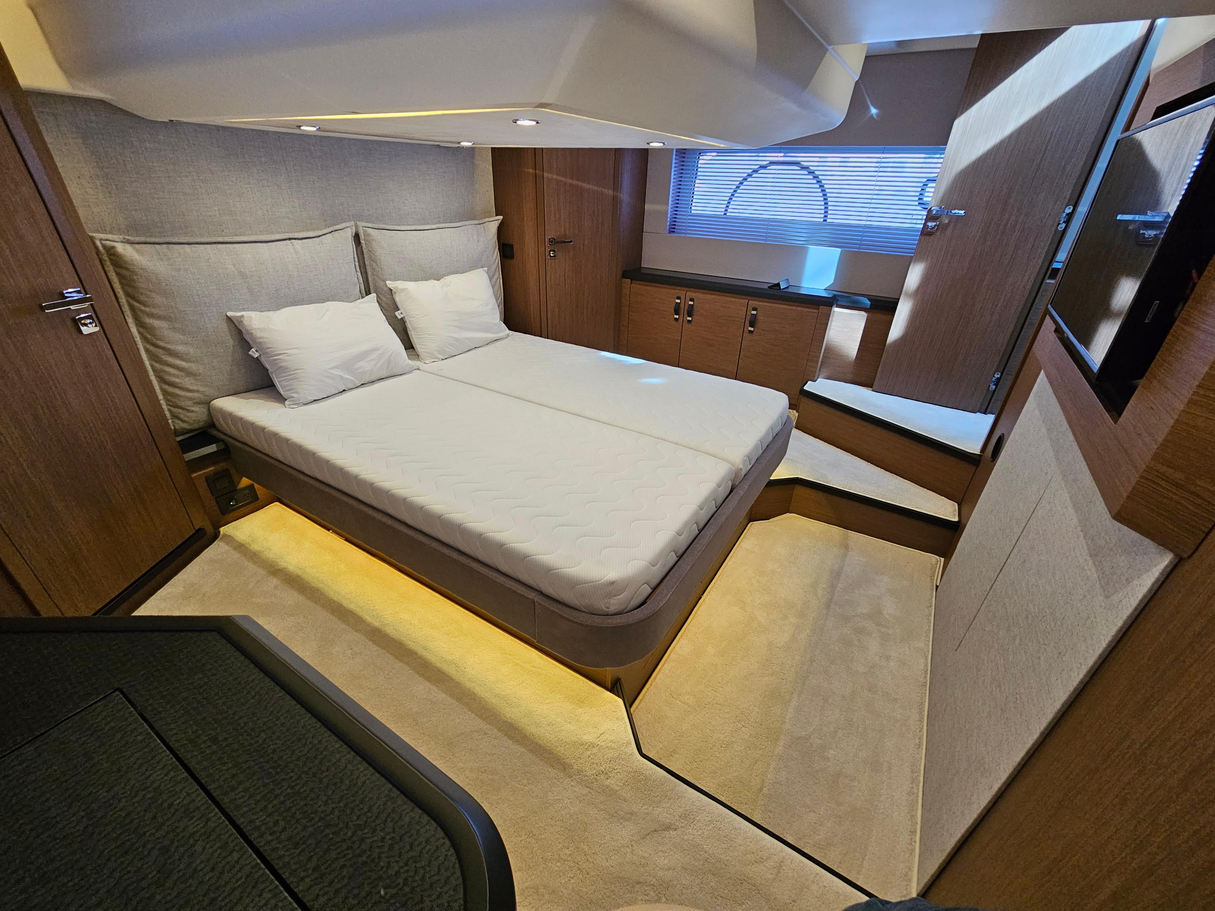 Luxurious bedroom interior of 2021 Beneteau Monte Carlo 52 yacht with modern design.