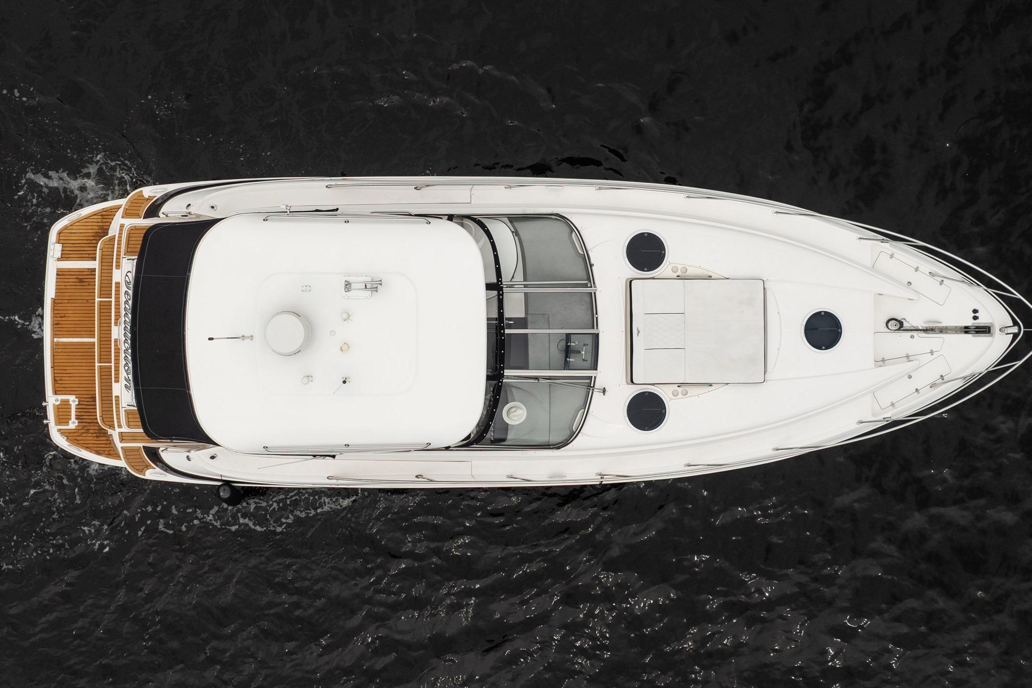Overhead view of 2008 Regal Commodore 4460 yacht on dark water.