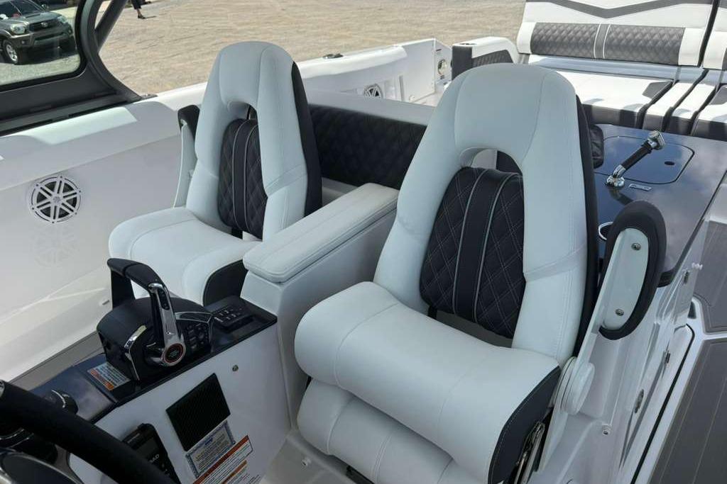 Luxury seating and controls on 2026 Monterey Elite 30 OB boat interior.