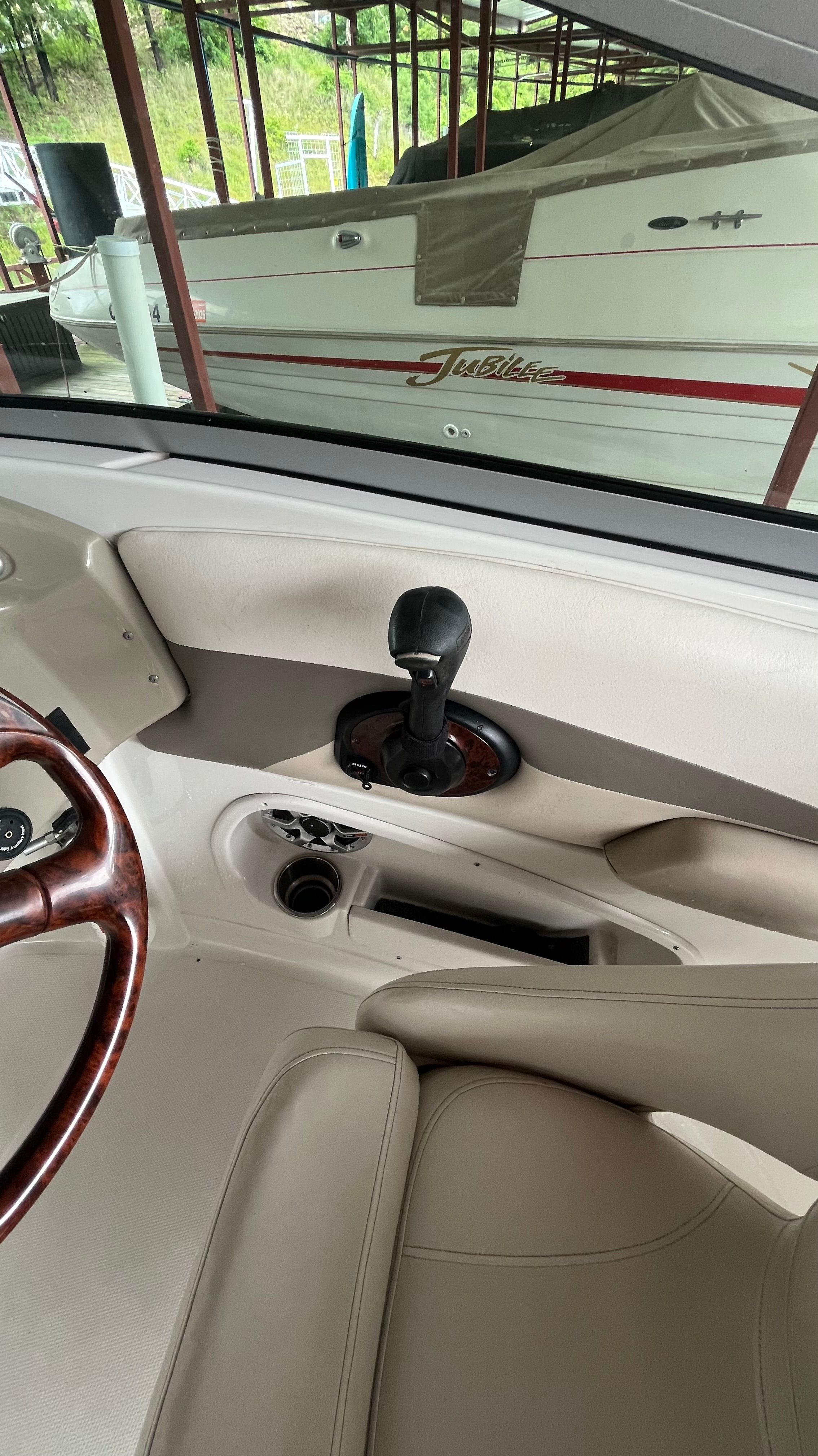 Interior view of a 2008 Crownline 252EX boat with steering wheel and throttle.