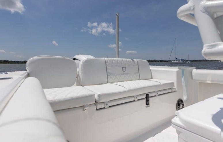 2026 Sea Fox 228 Commander boat interior with white seating, under a clear blue sky.