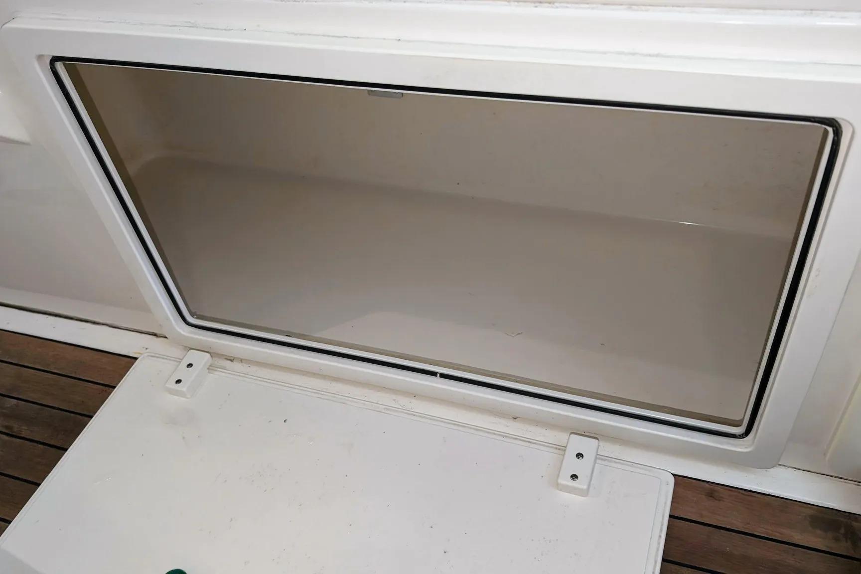 Open storage compartment on a 2017 Boston Whaler 320 Vantage boat.
