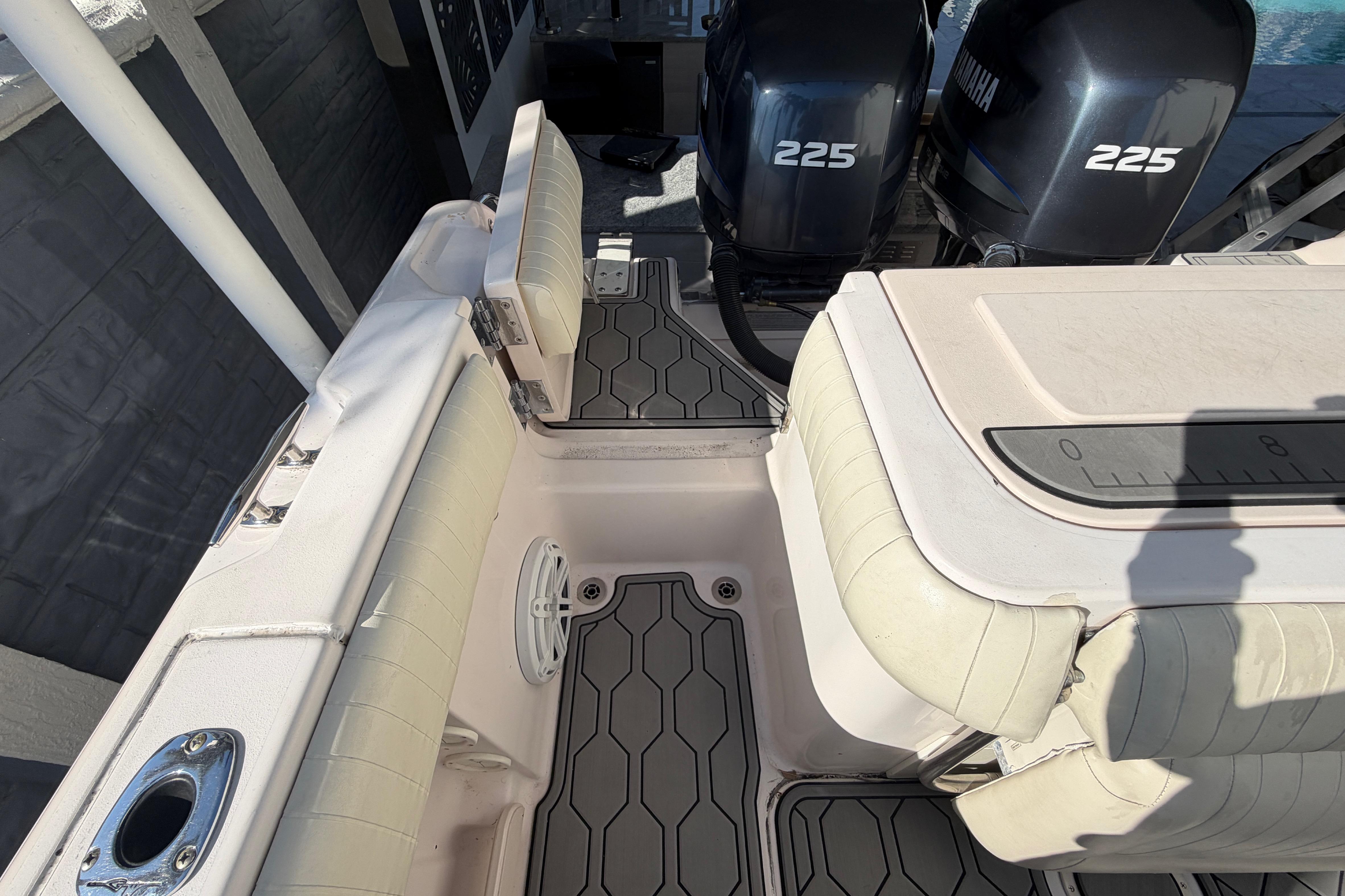 2004 Grady White 273 boat interior with Yamaha 225 engines, featuring cushioned seating and deck.