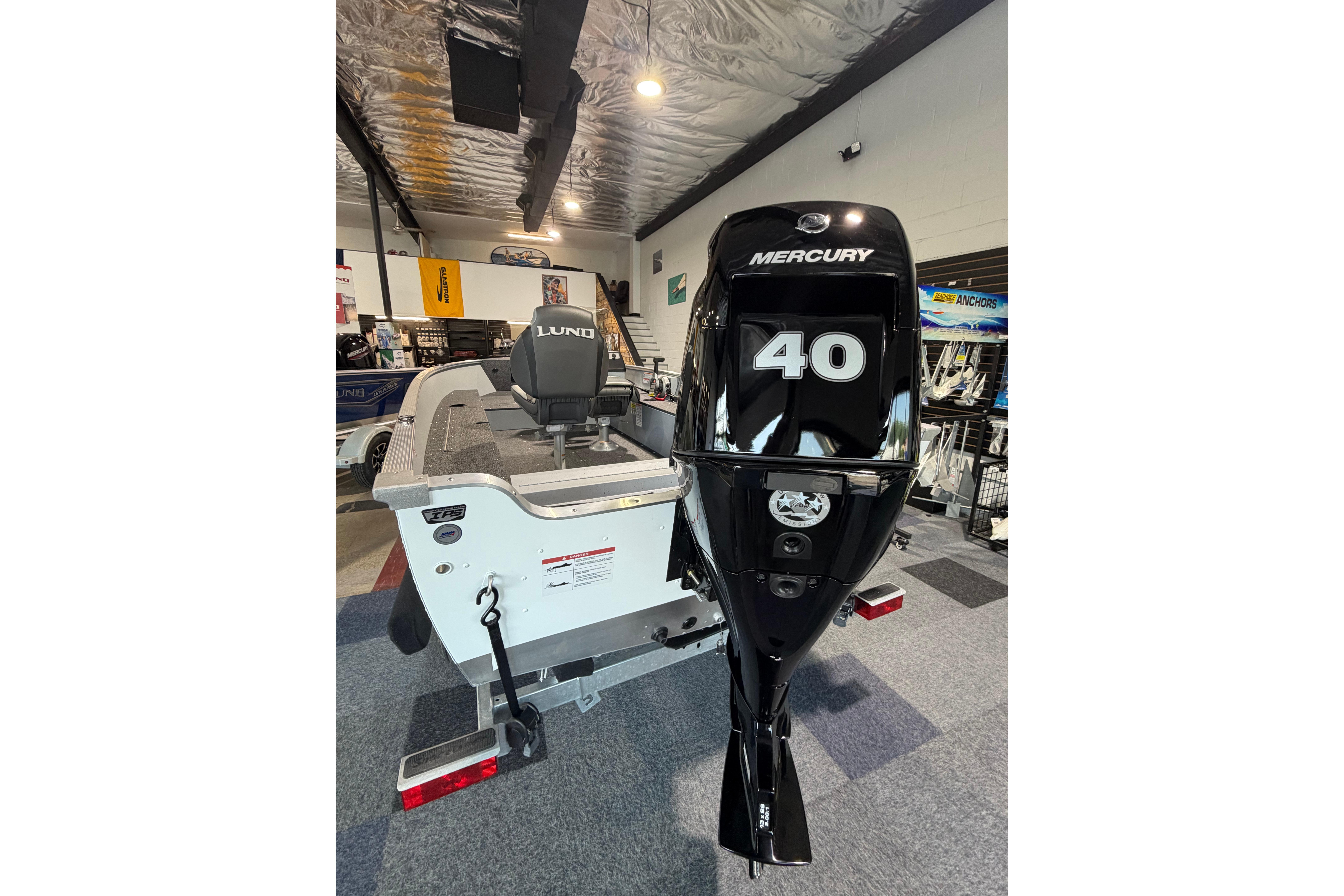 2027 Lund 1600 Fury SS boat with Mercury 40 HP engine in showroom.