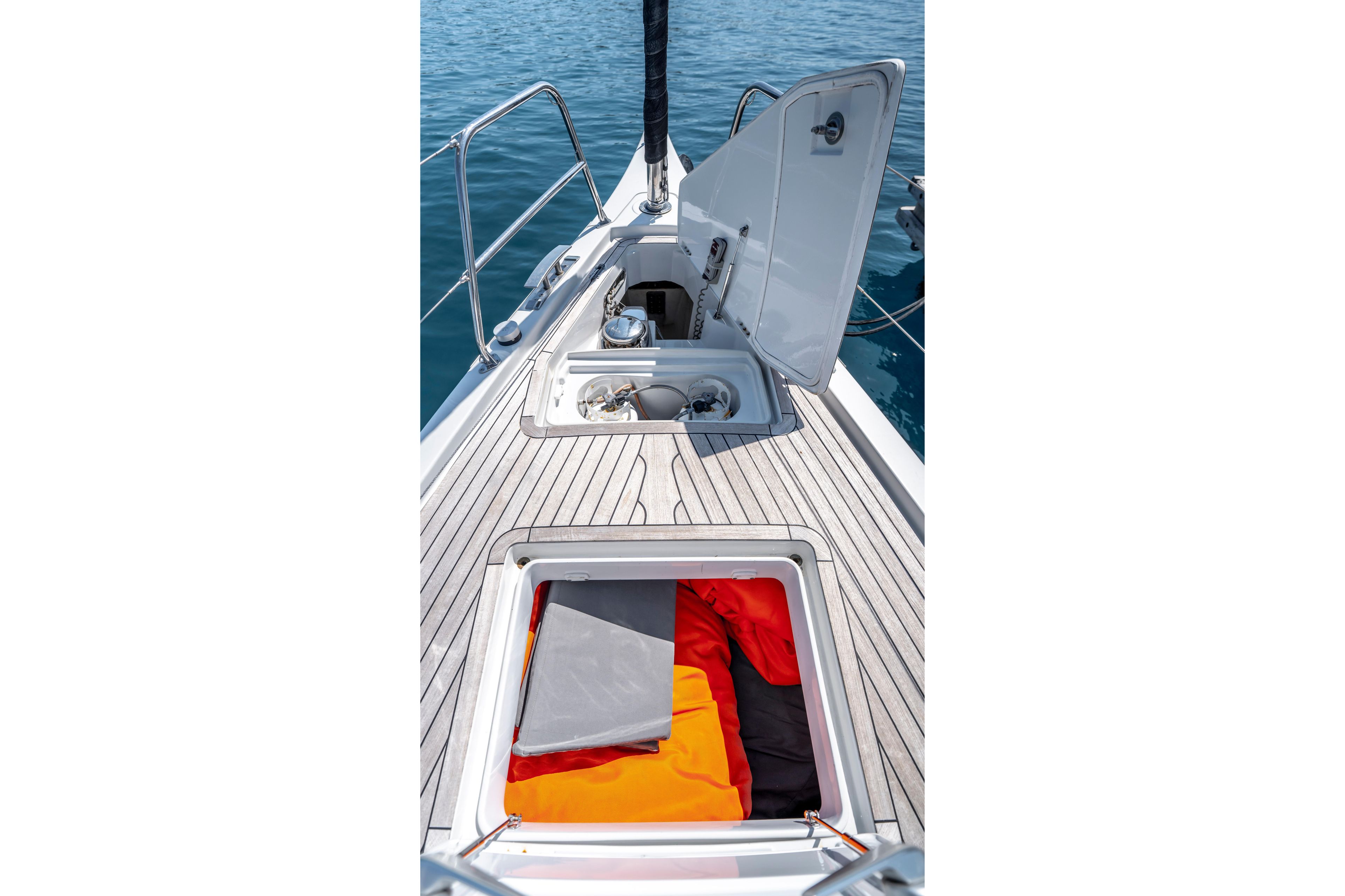 2016 Grand Soleil 58 yacht deck with open storage compartments and vibrant gear.