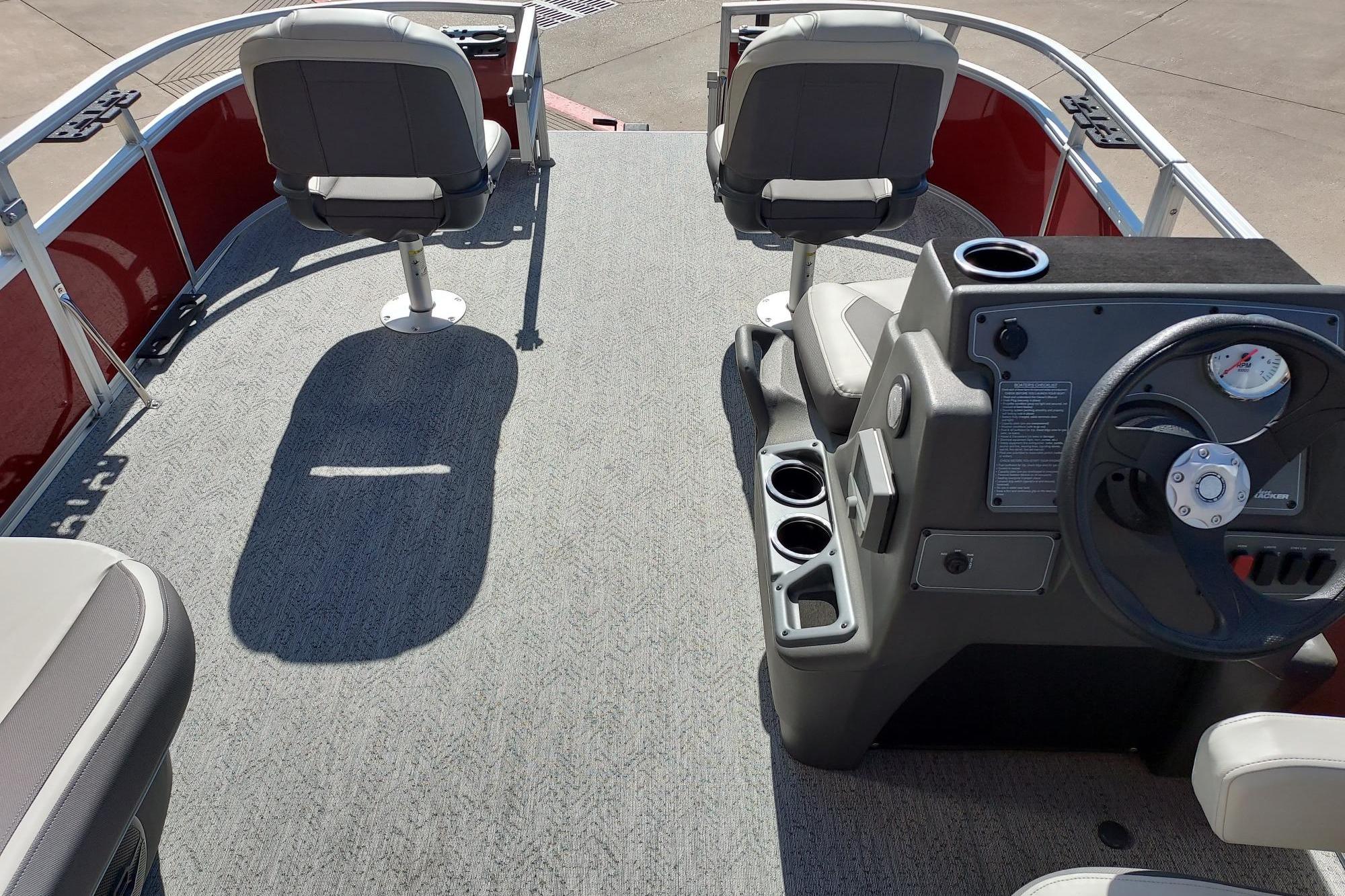 2026 Sun Tracker Bass Buggy 16 XL Select pontoon boat interior with seating and steering console.