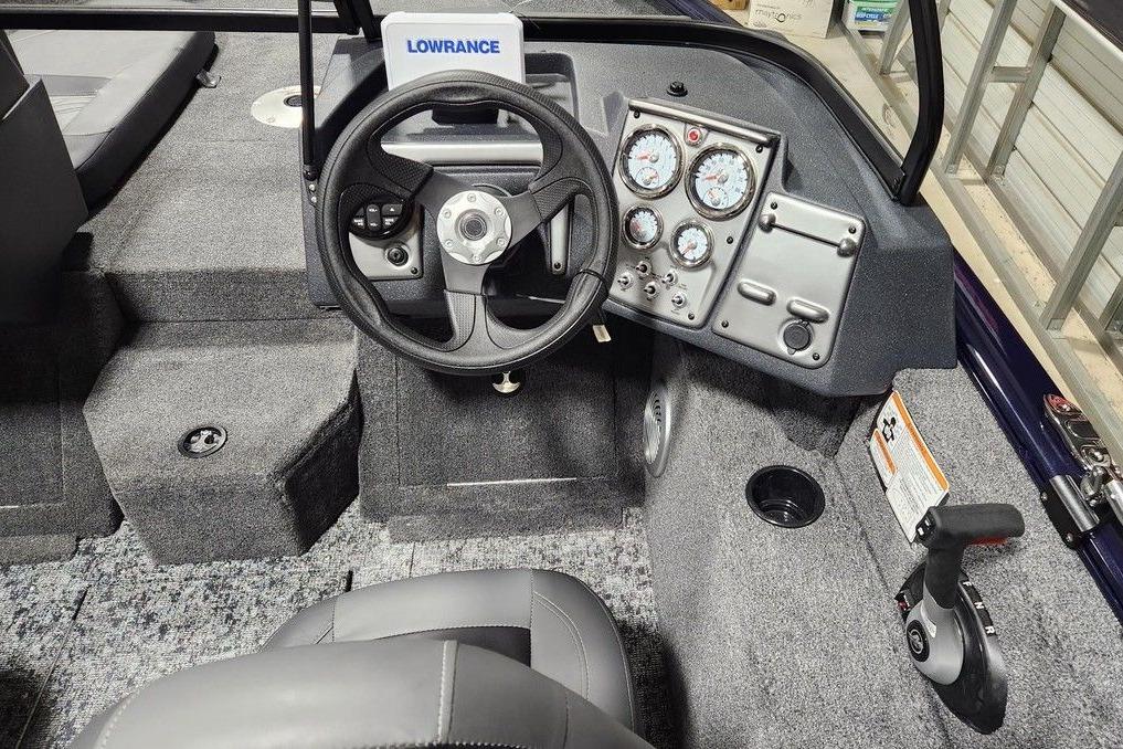 2026 Tracker Pro Guide V-175 Combo boat cockpit with steering wheel and instrument panel.