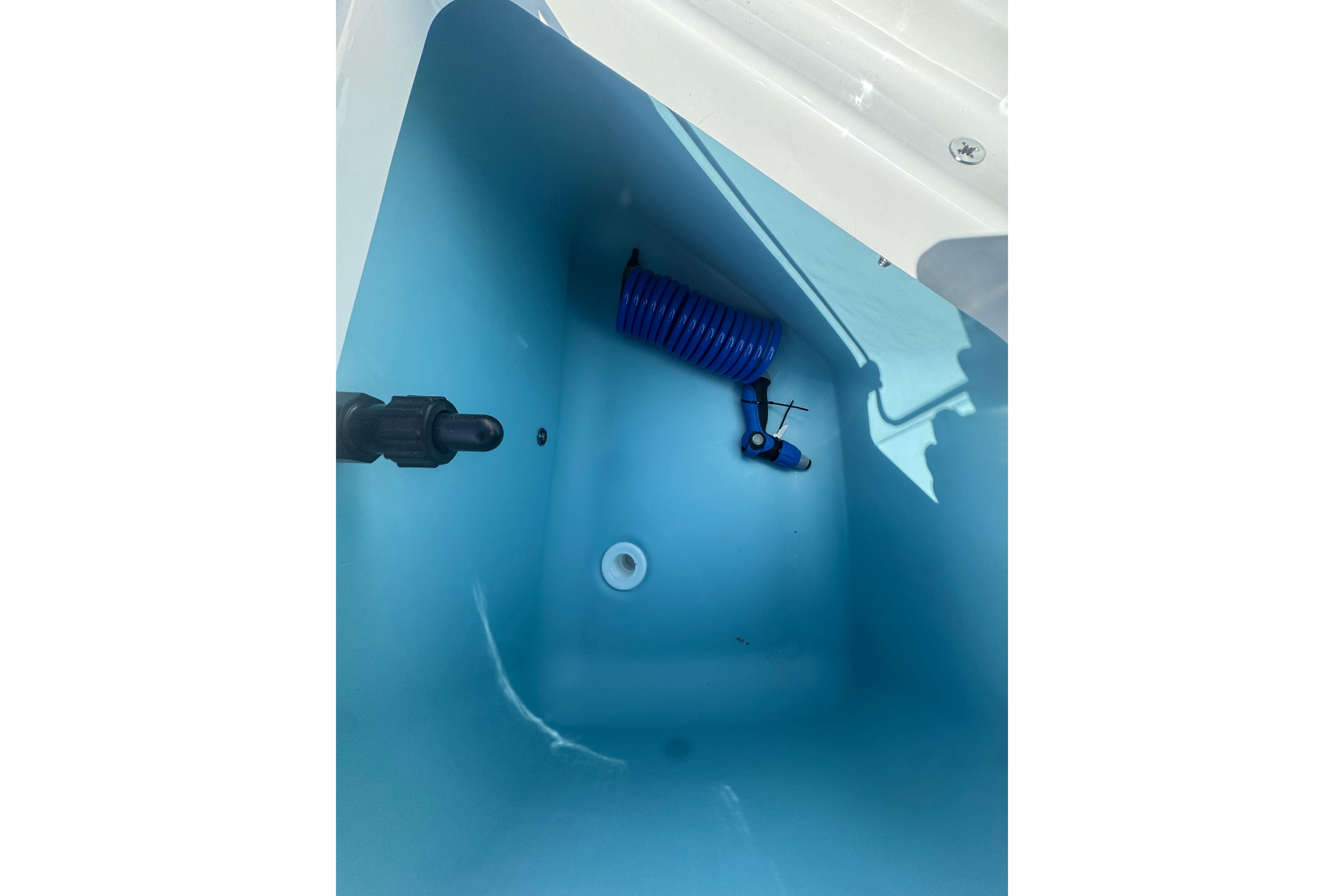 Interior view of Yamaha Boats 2026 model 222 FSH Sport E, featuring a blue compartment.