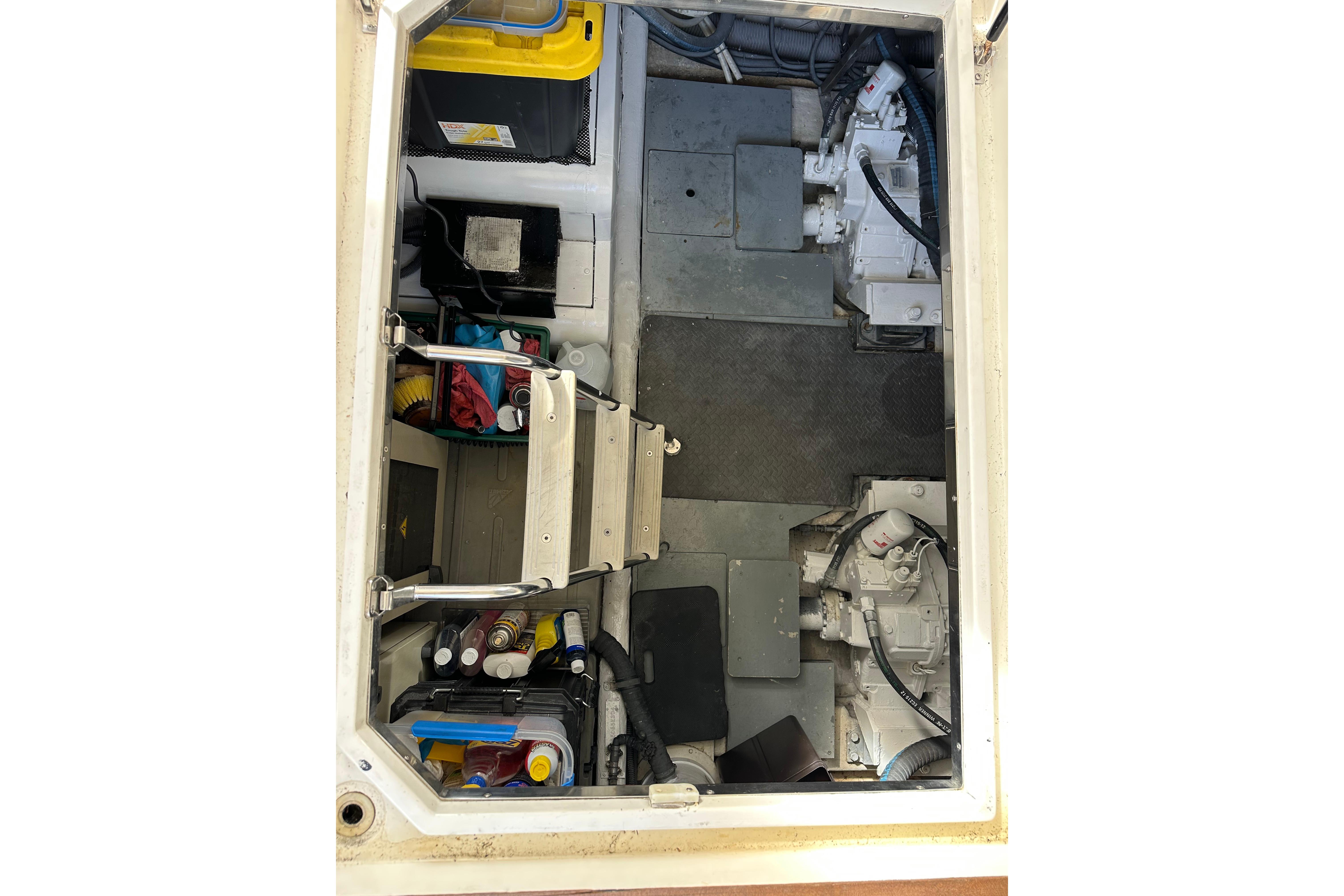Engine room of a 2004 Azimut 55E yacht, featuring equipment and storage.