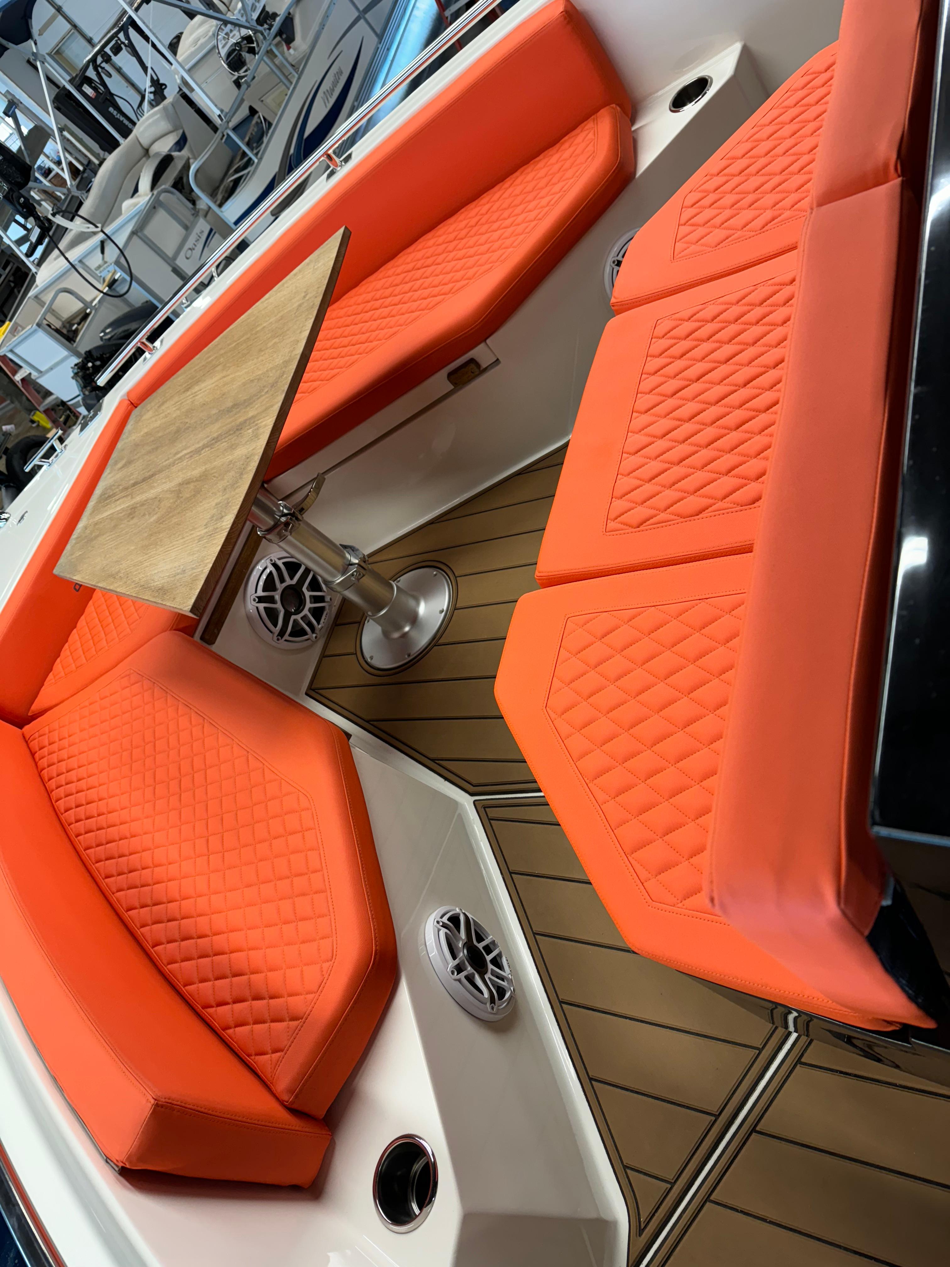 De Antonio Yachts D 28 2020 model with orange seating and wooden table.